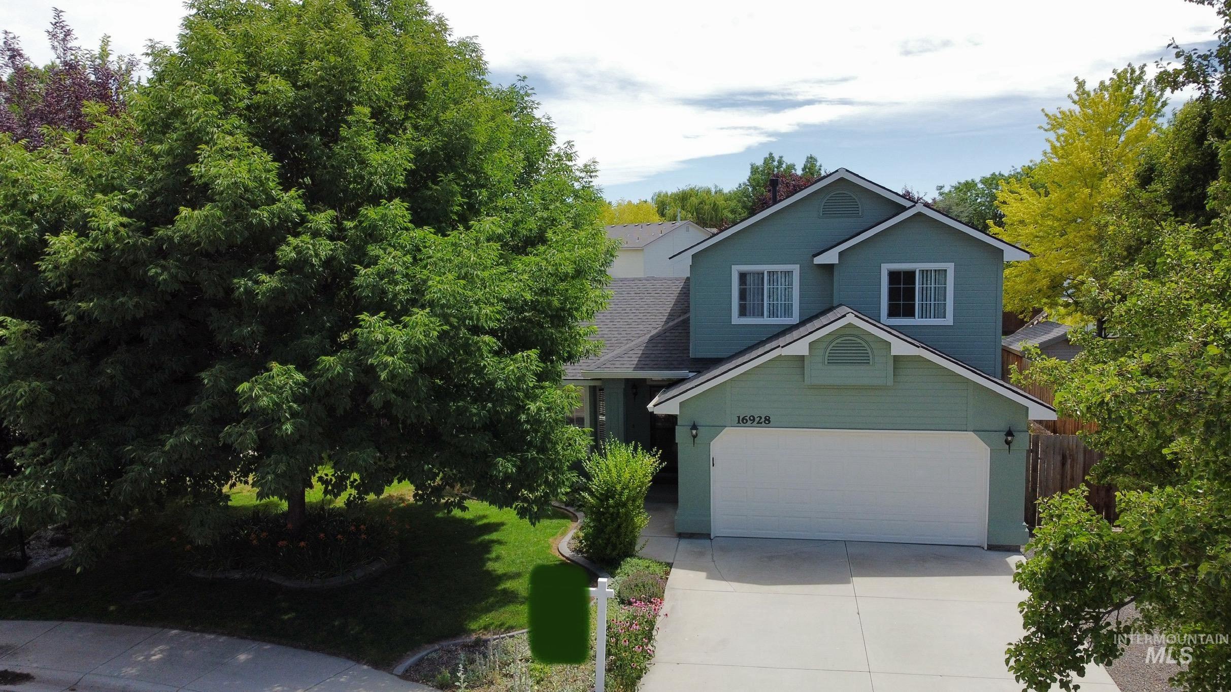View of front of property featuring concrete driveway