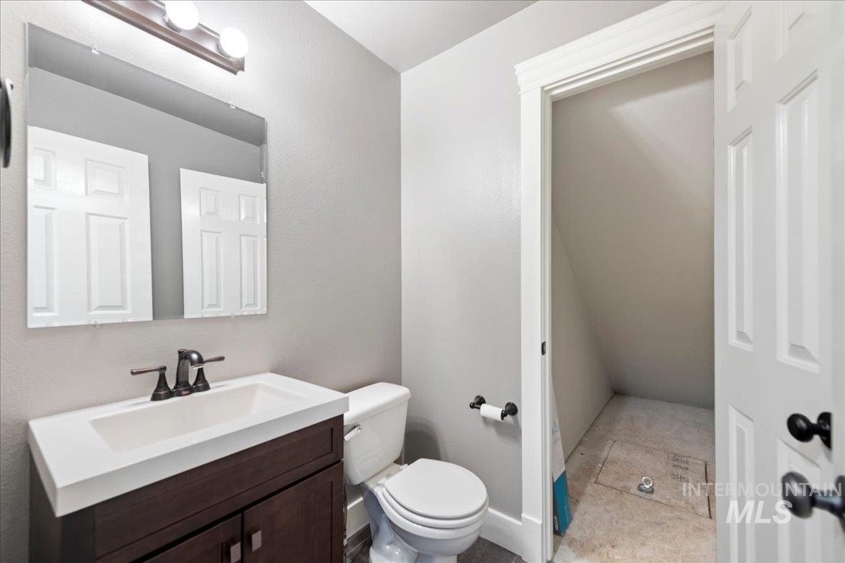 Half bathroom with toilet and vanity
