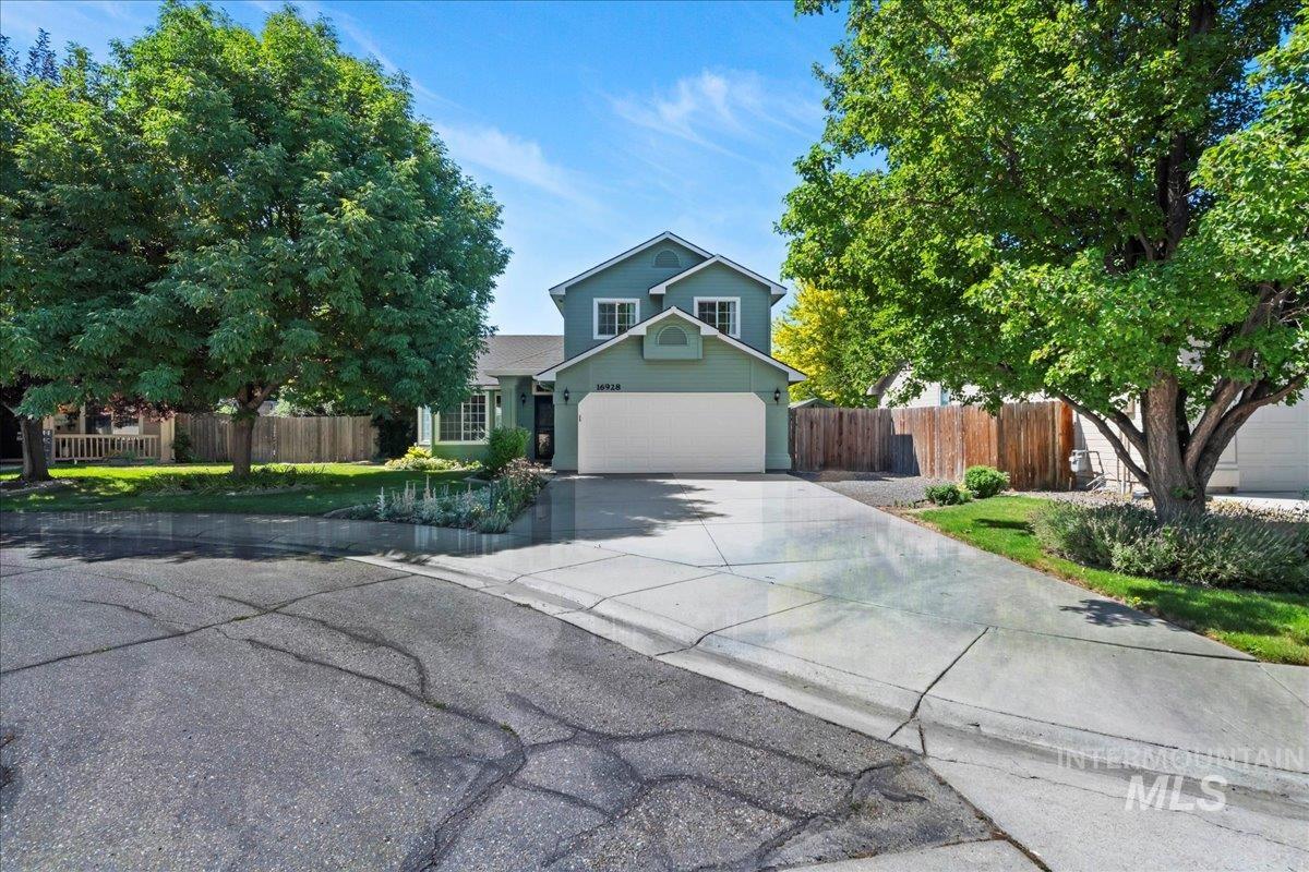 Traditional-style house with driveway and an attached garage