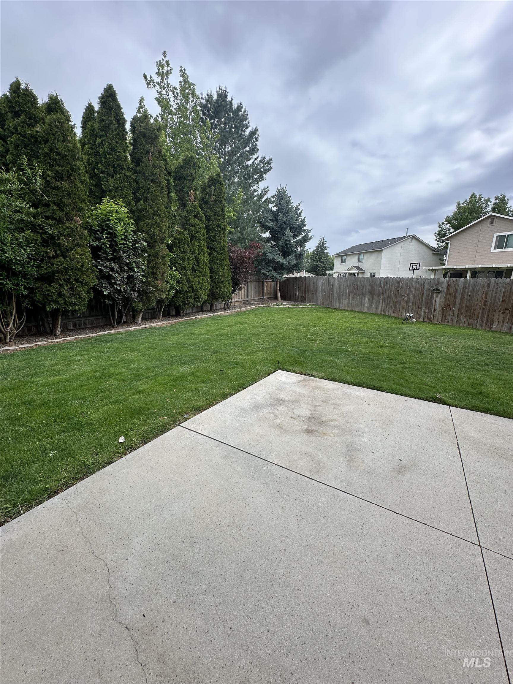 Fenced backyard featuring a patio