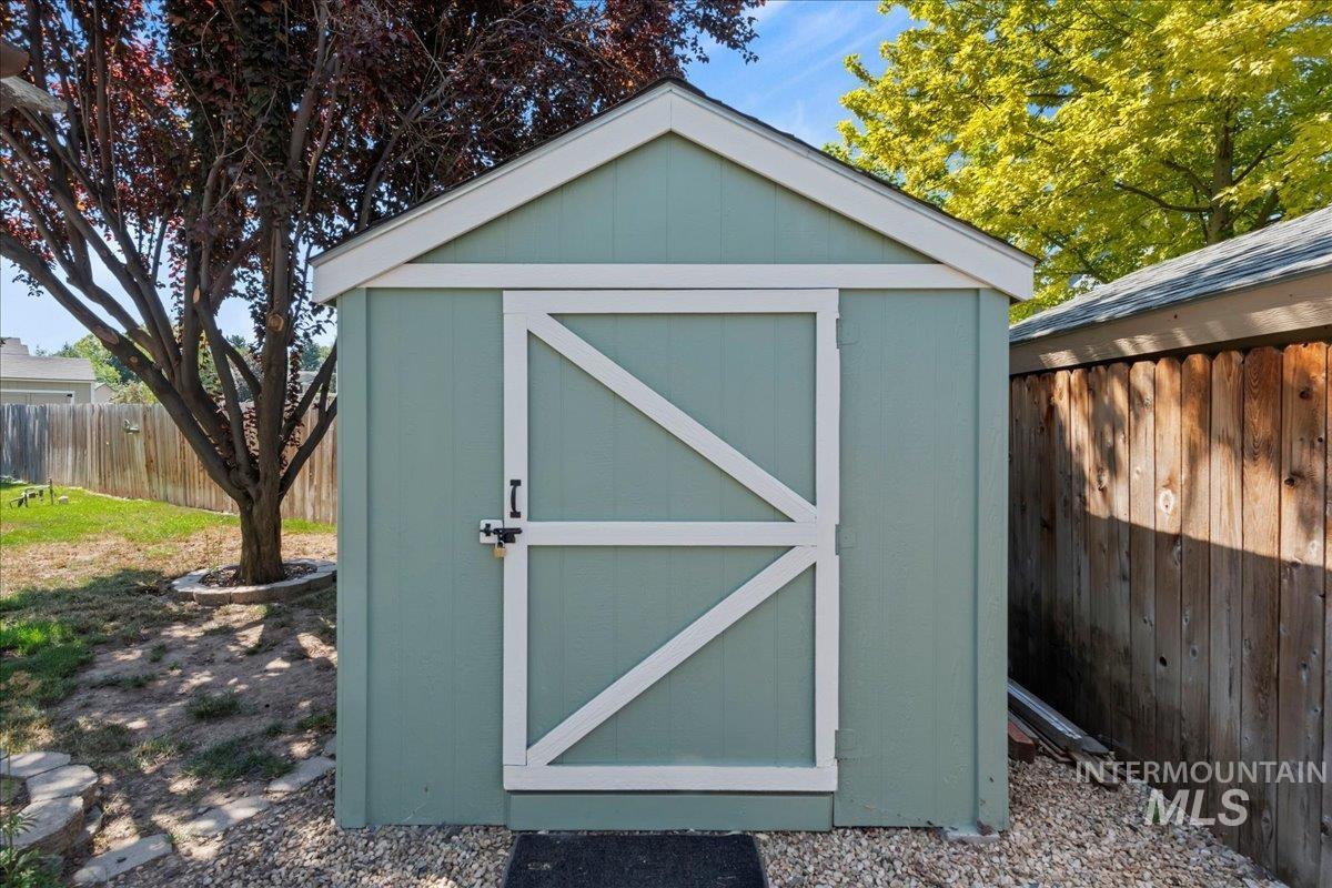 View of shed with a fenced backyard