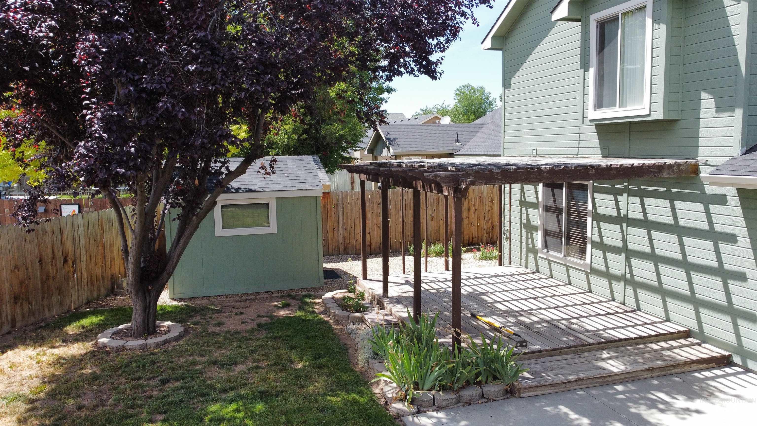 Fenced backyard featuring a patio area, a storage shed, and a pergola