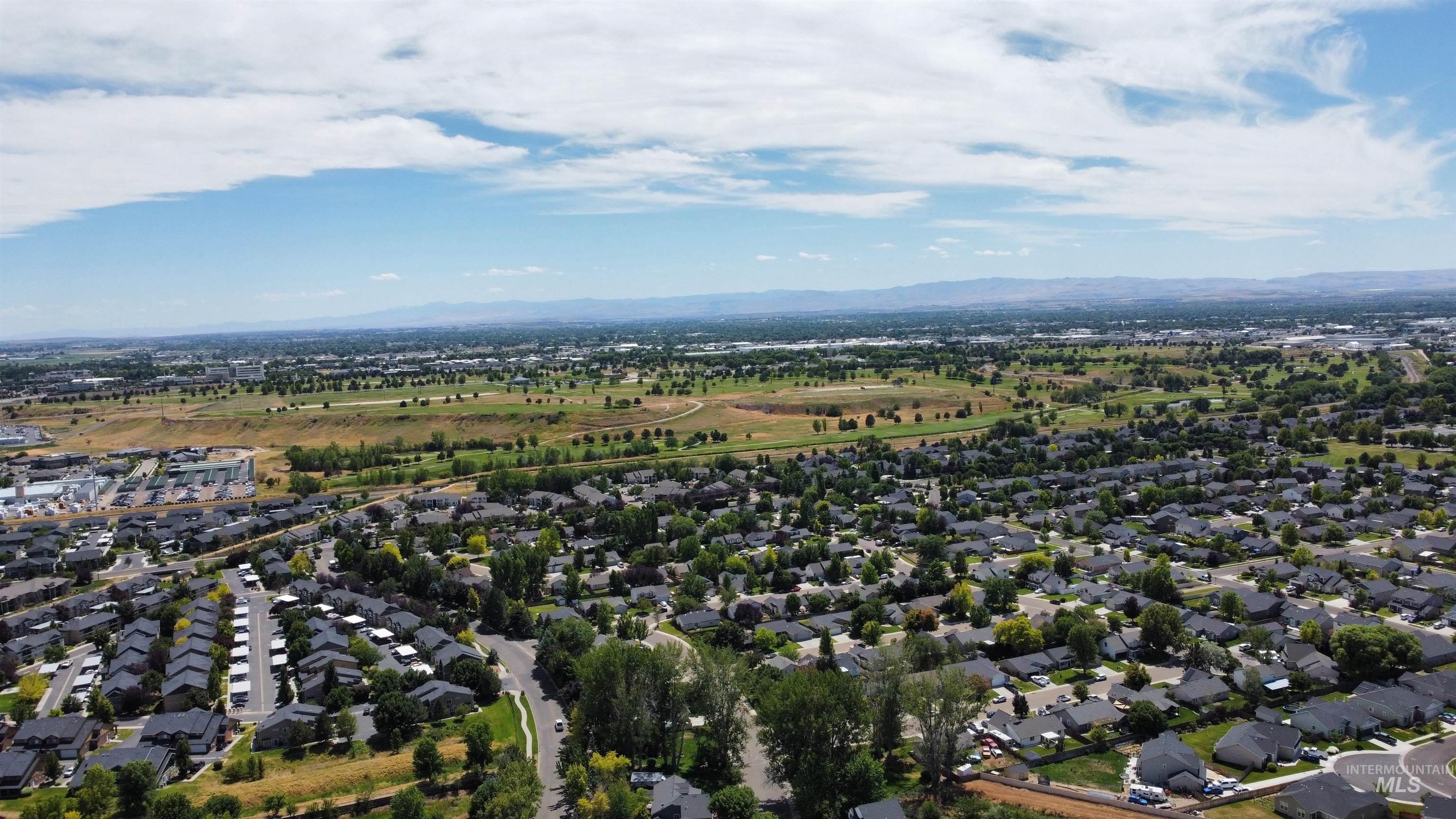 View of property location featuring nearby suburban area and mountains