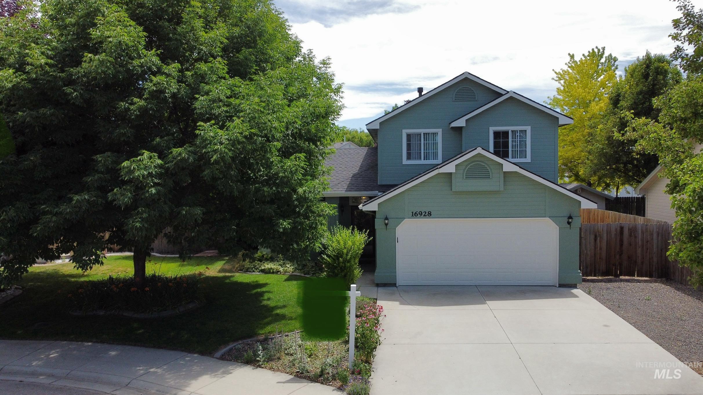 Traditional-style home with concrete driveway