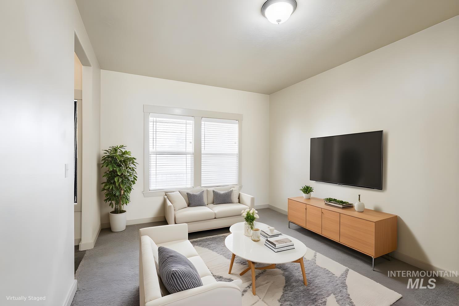 Carpeted living room featuring baseboards