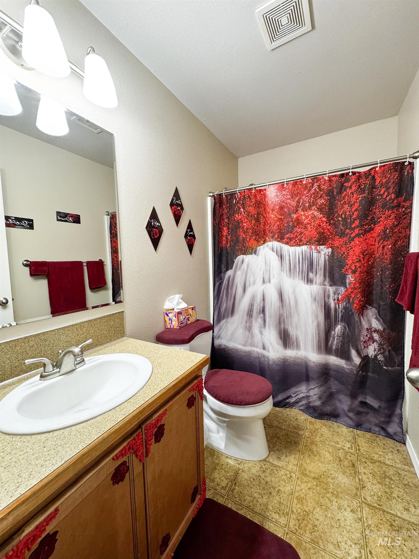 Bathroom featuring vanity and a shower with curtain