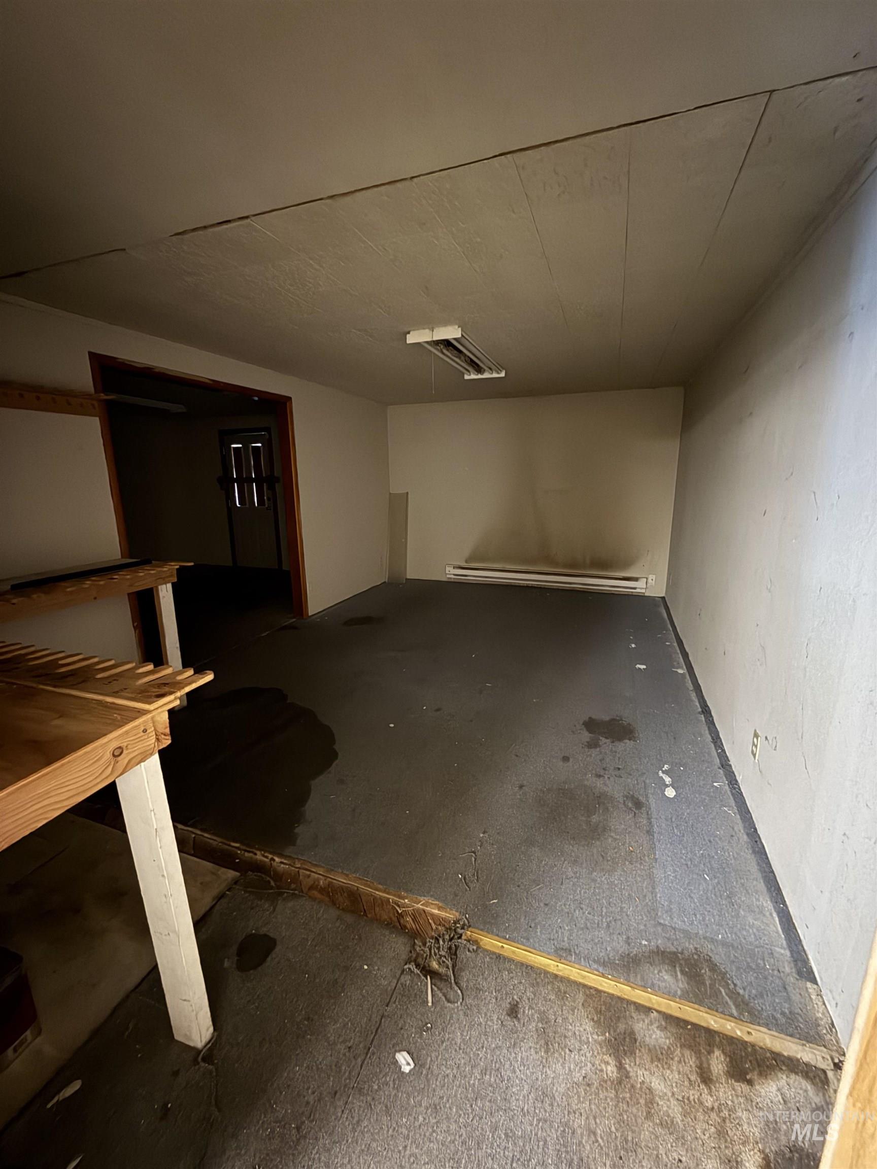 Basement featuring baseboard heating