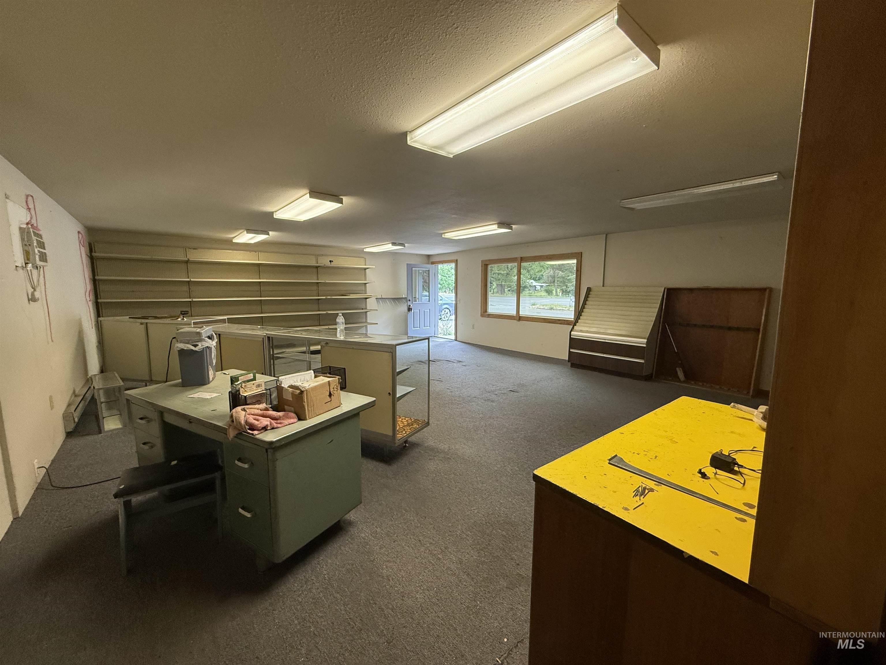 Basement featuring dark colored carpet