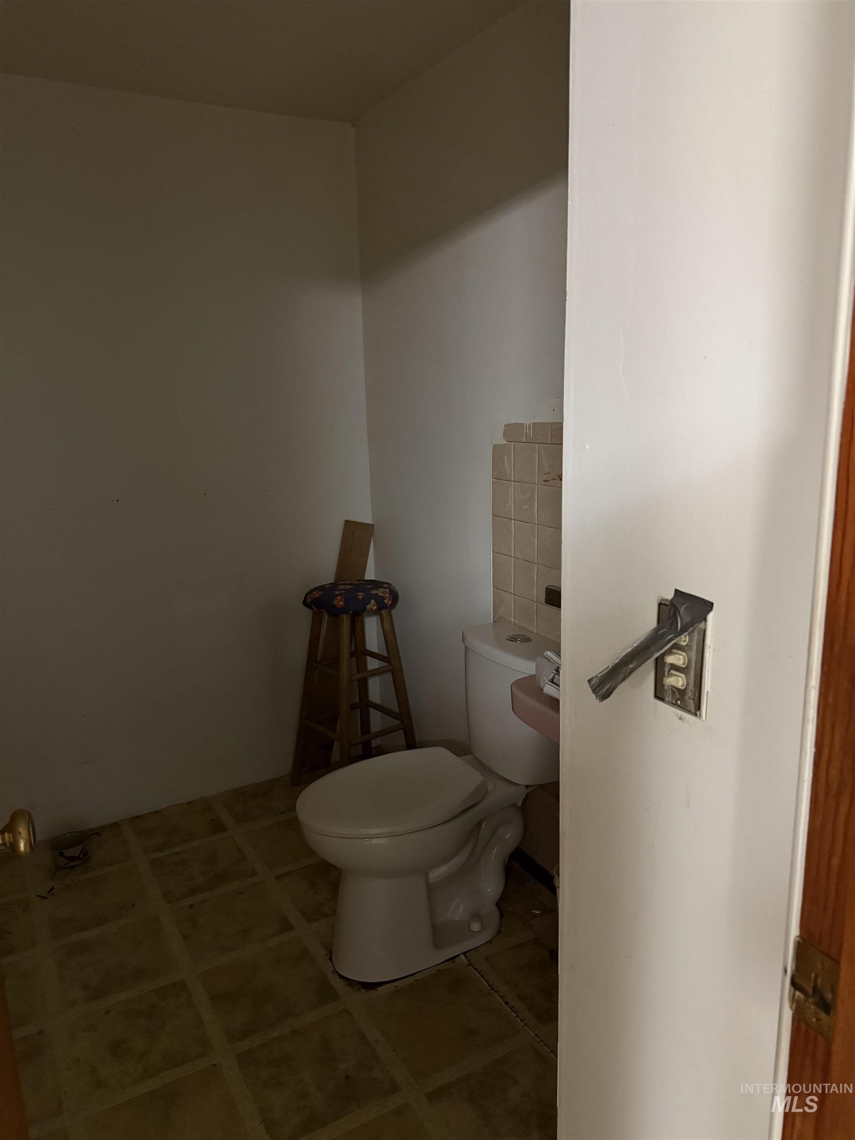 Bathroom featuring toilet and tile patterned flooring
