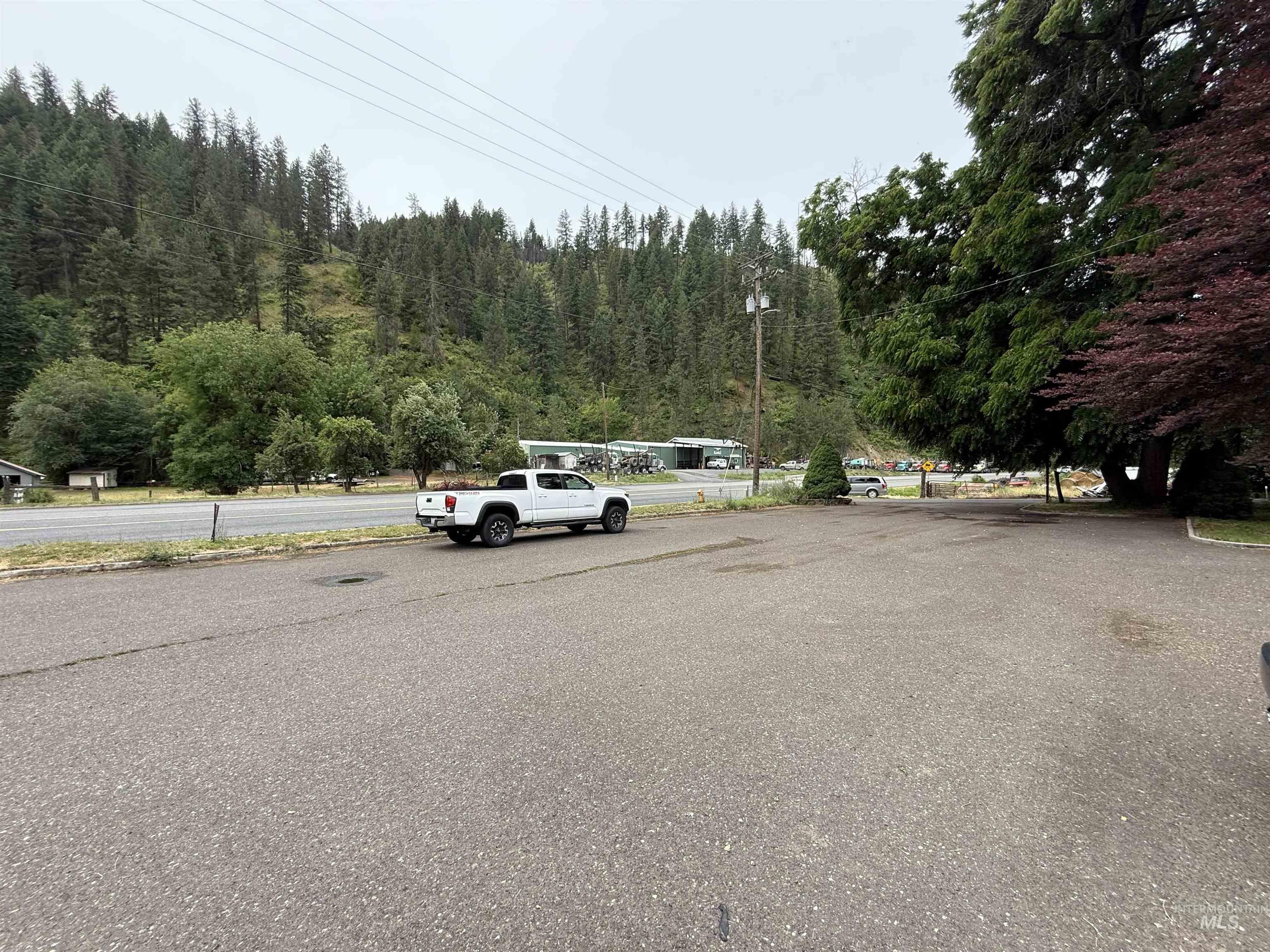 View of asphalt road with a view of trees