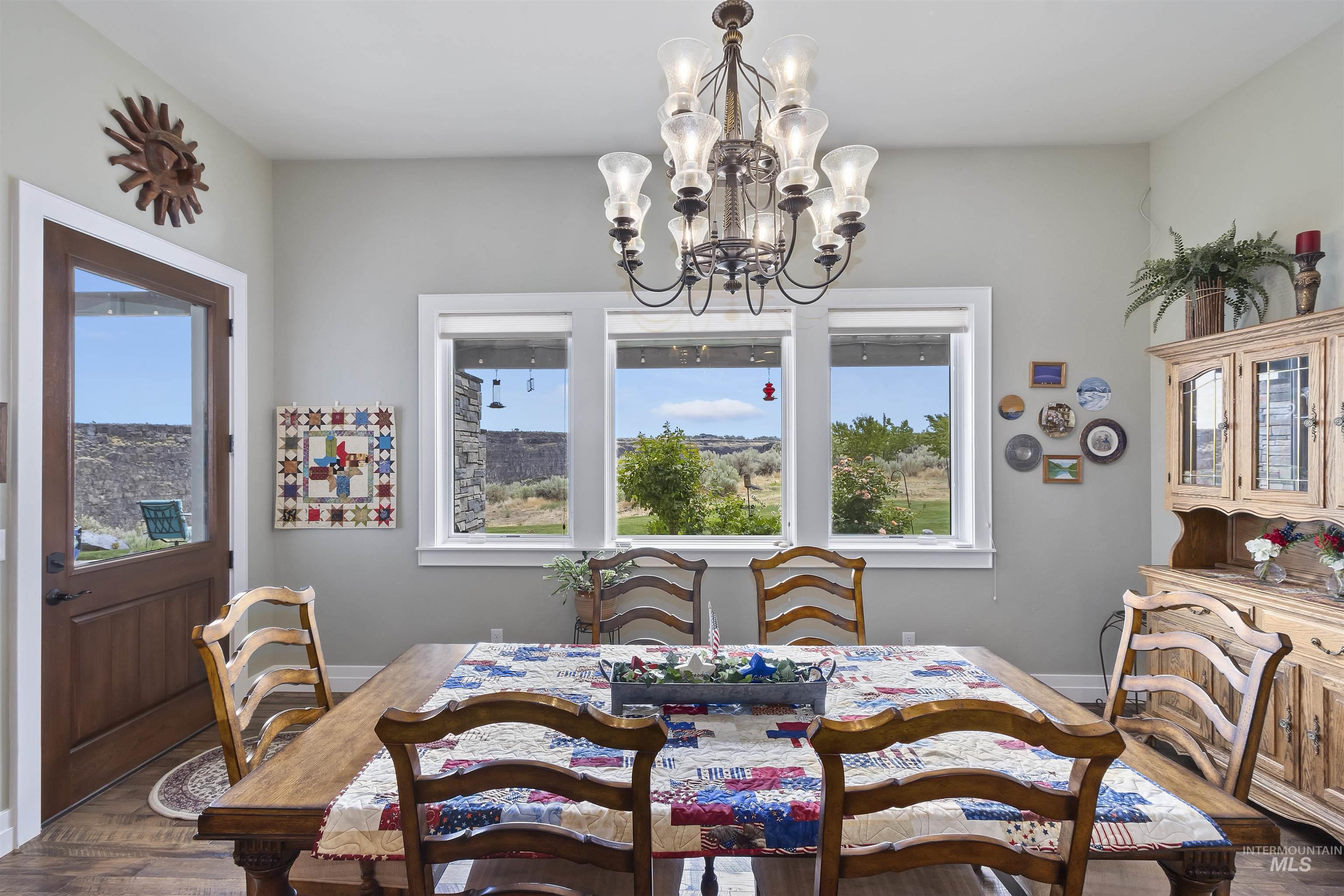 Dining space featuring a chandelier and wood finished floors