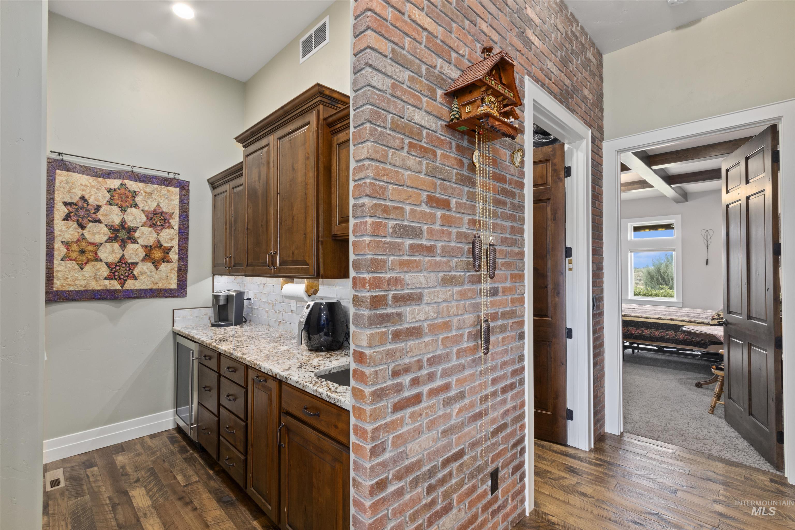 Bar area featuring dark wood-style floors