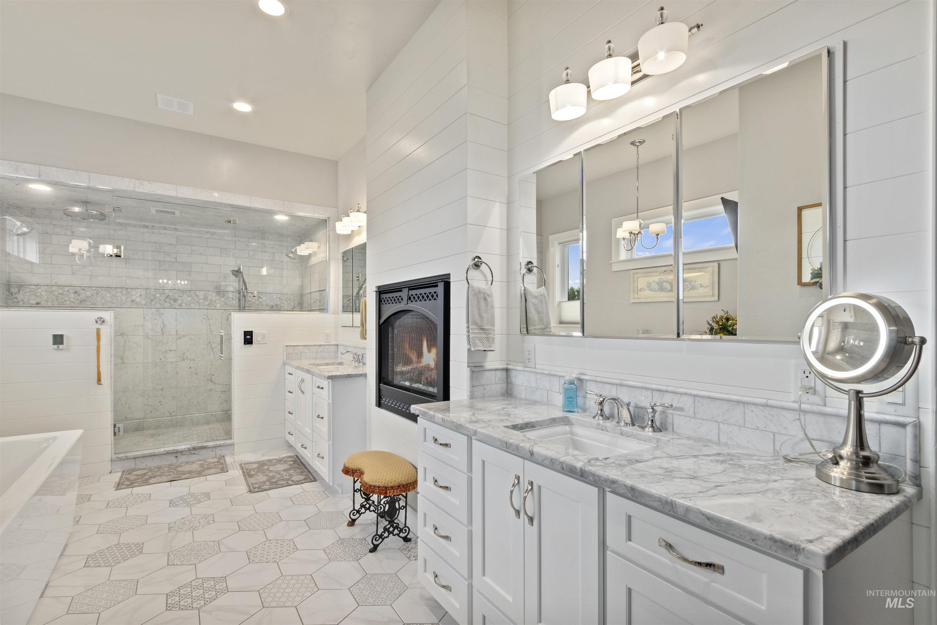 Full bathroom with vanity, a stall shower, a garden tub, tile patterned flooring, and recessed lighting