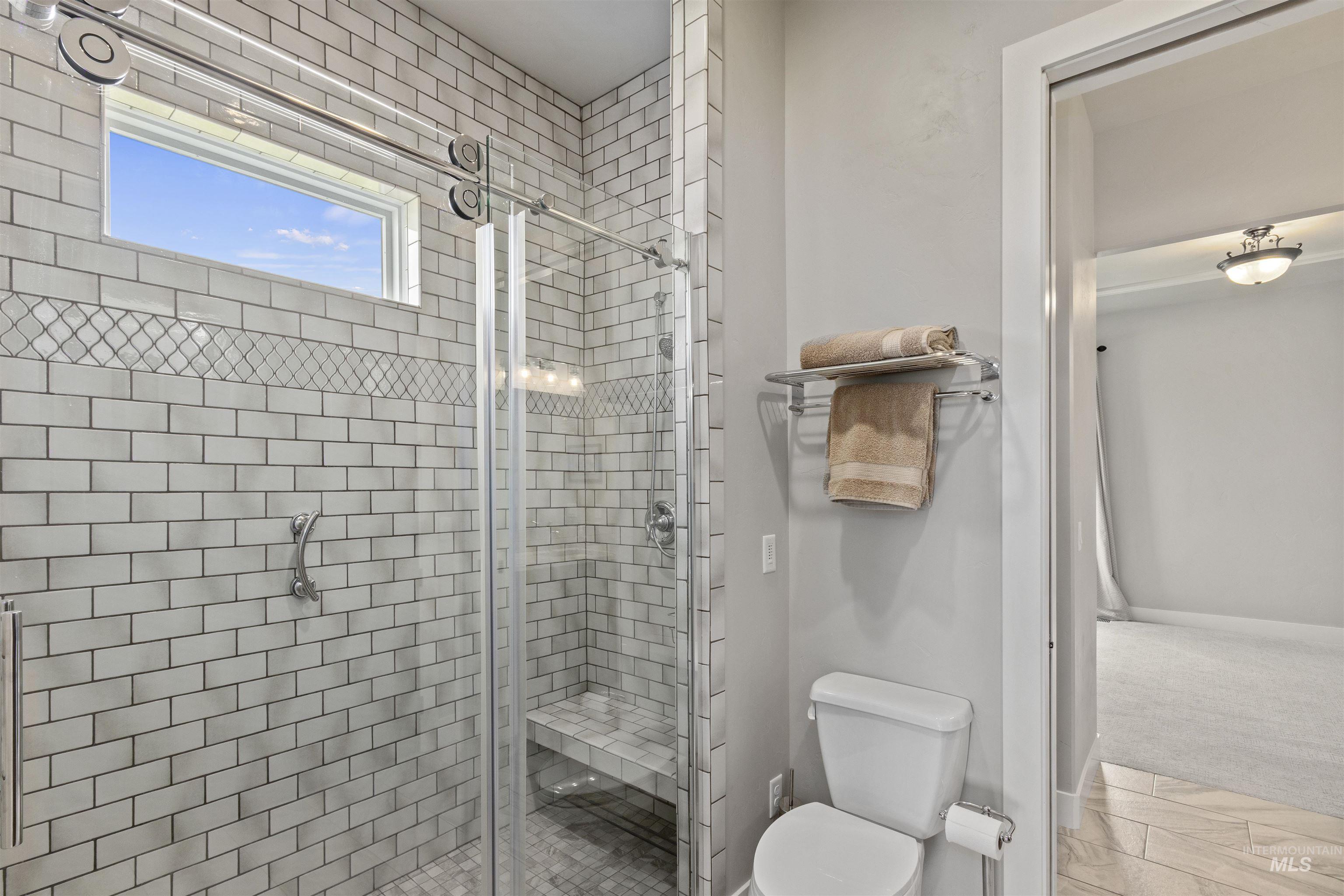 Full bath with a stall shower and toilet