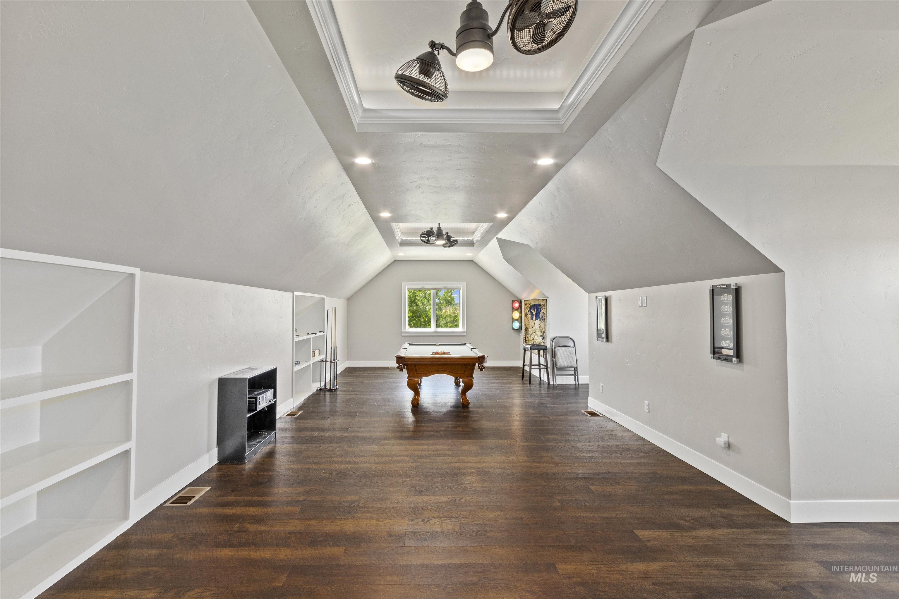 Playroom with built in shelves, wood finished floors, recessed lighting, billiards table, and vaulted ceiling