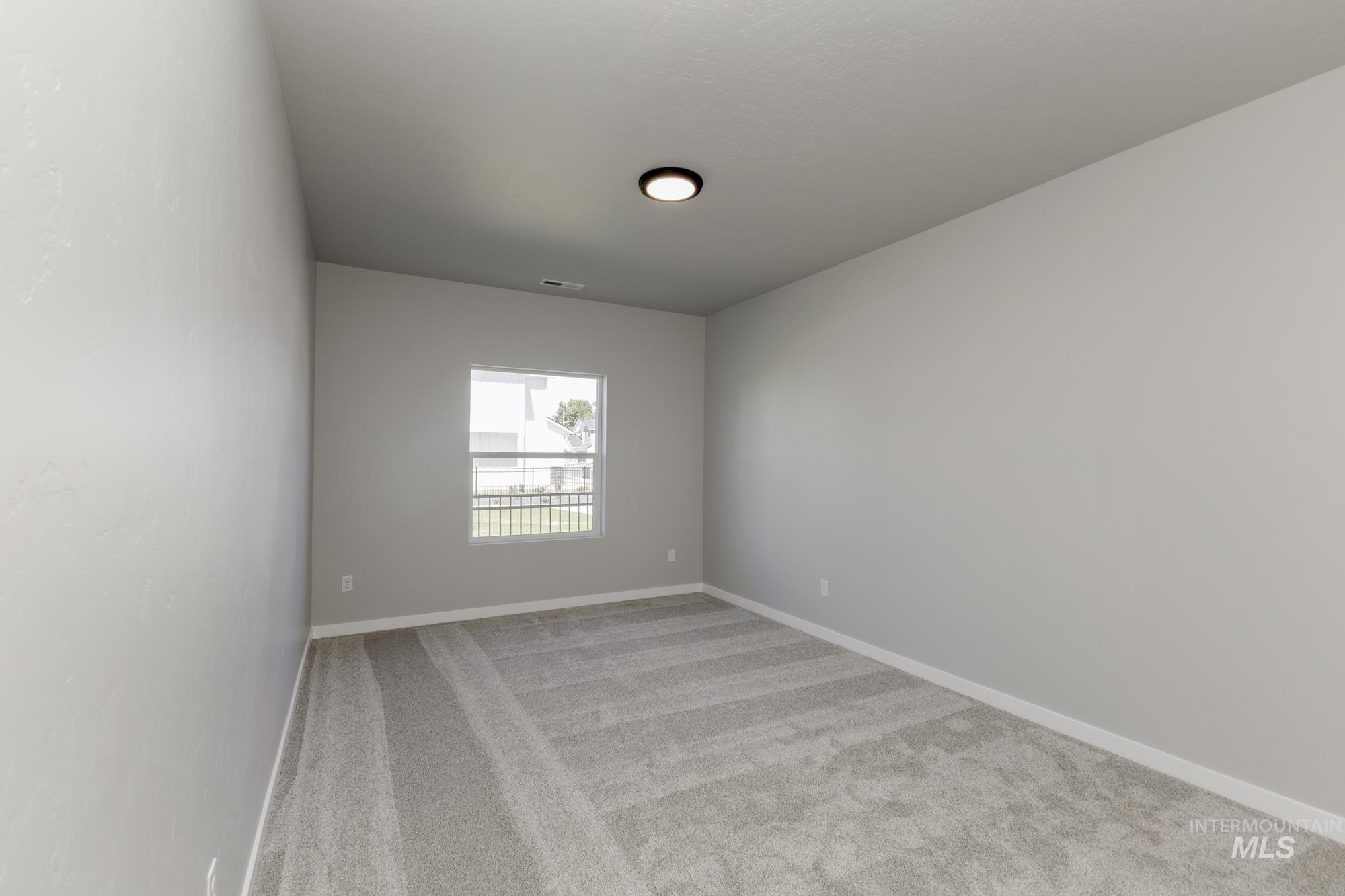 Unfurnished room with light carpet and baseboards