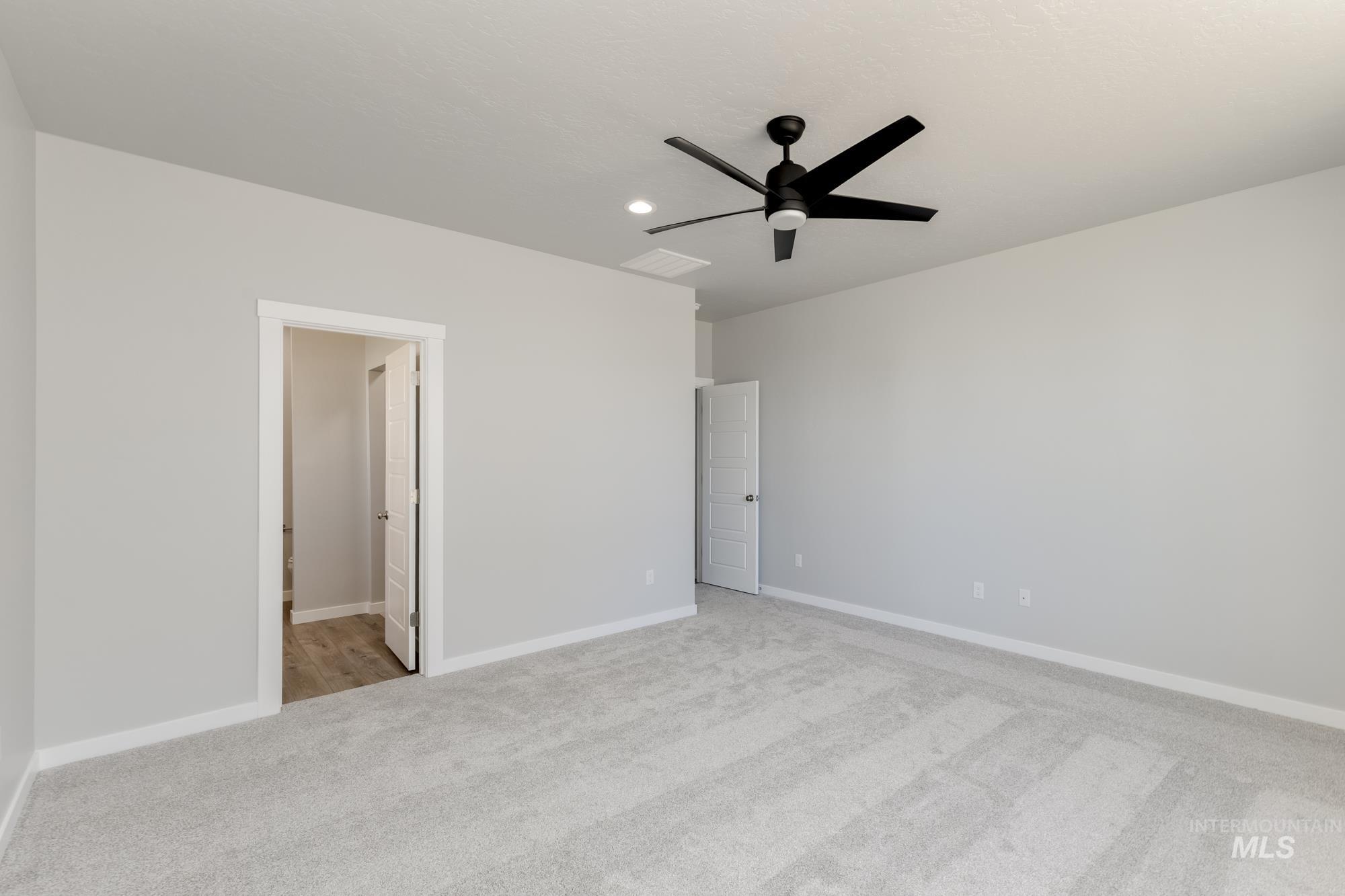 Unfurnished bedroom with carpet floors, recessed lighting, a ceiling fan, and ensuite bathroom