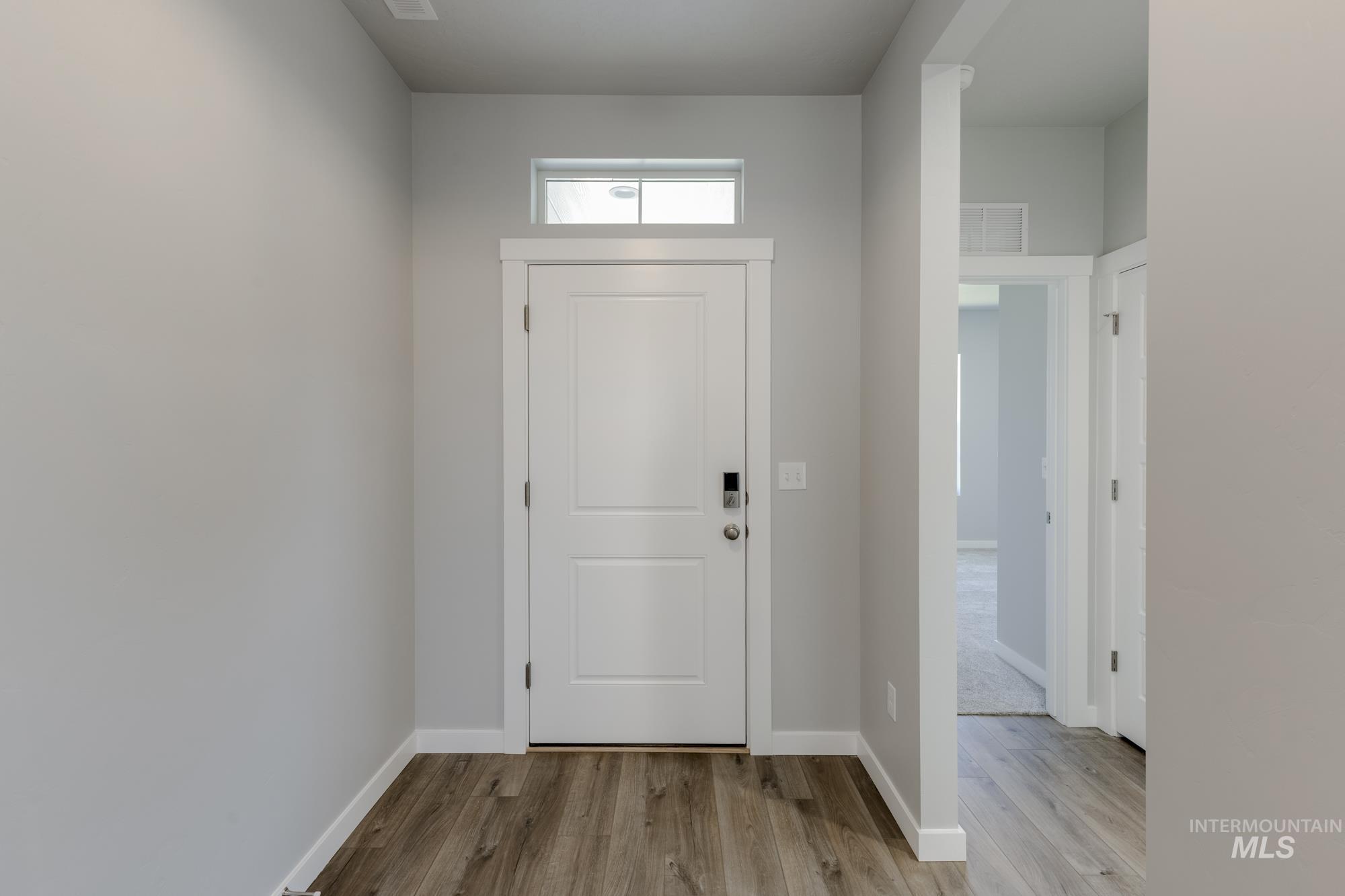 Foyer featuring wood finished floors and baseboards