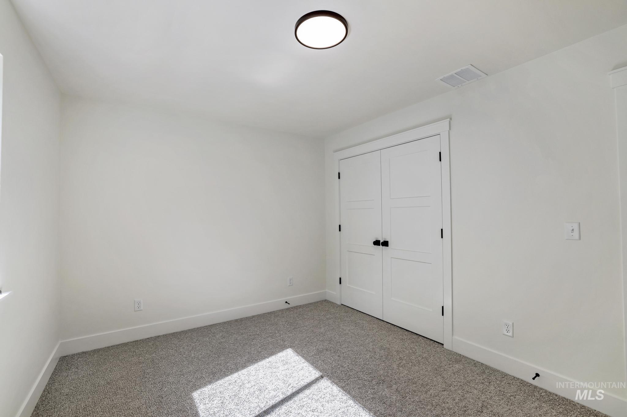 Unfurnished bedroom with carpet floors and a closet