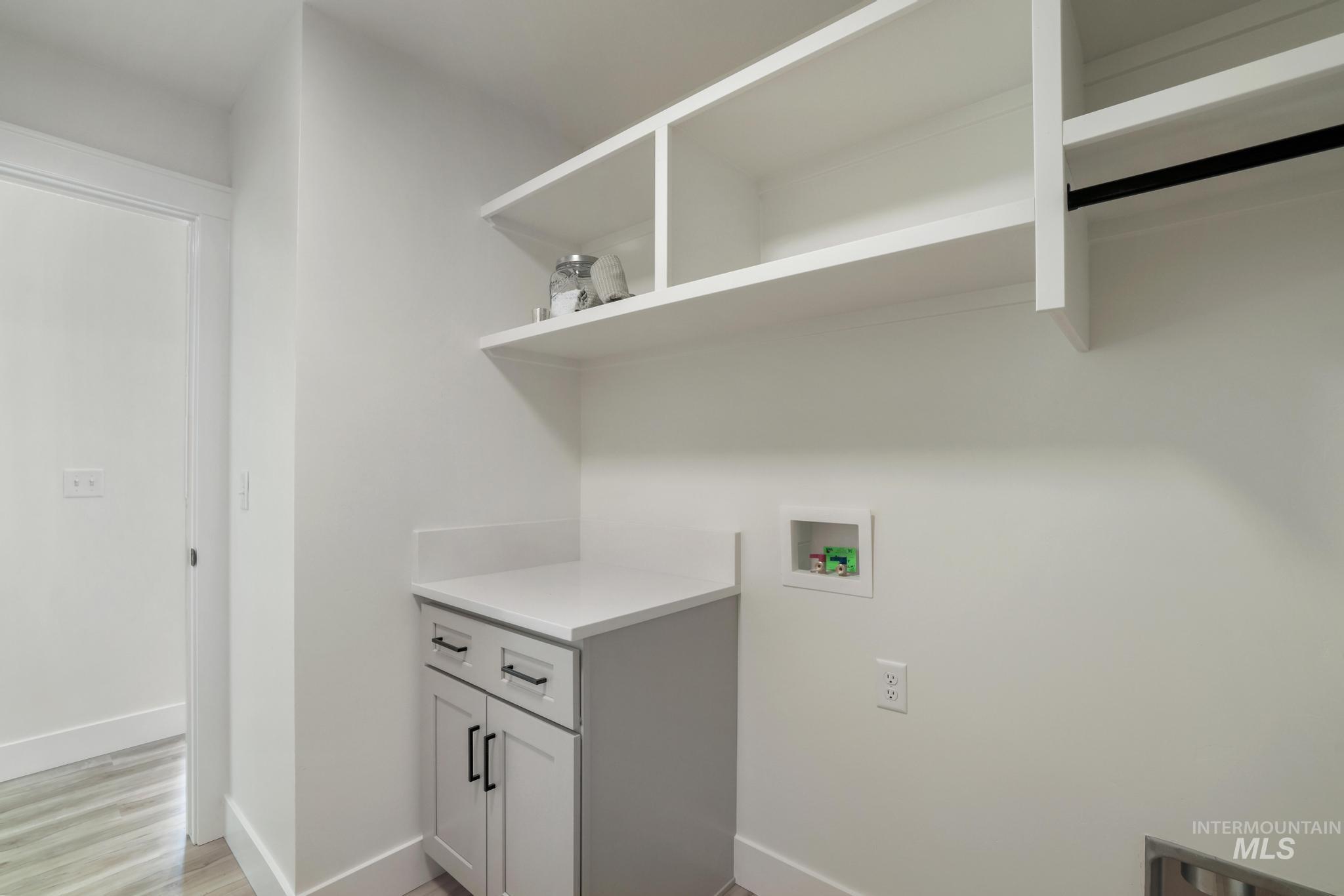 Laundry area featuring washer hookup and light wood-type flooring