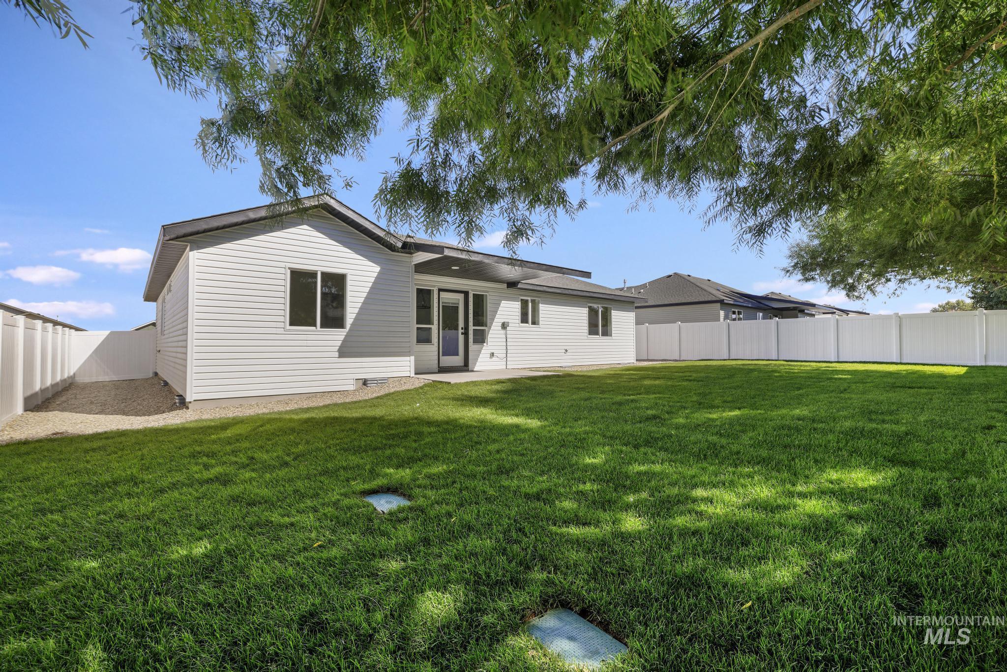 Rear view of property featuring a fenced backyard and a patio area