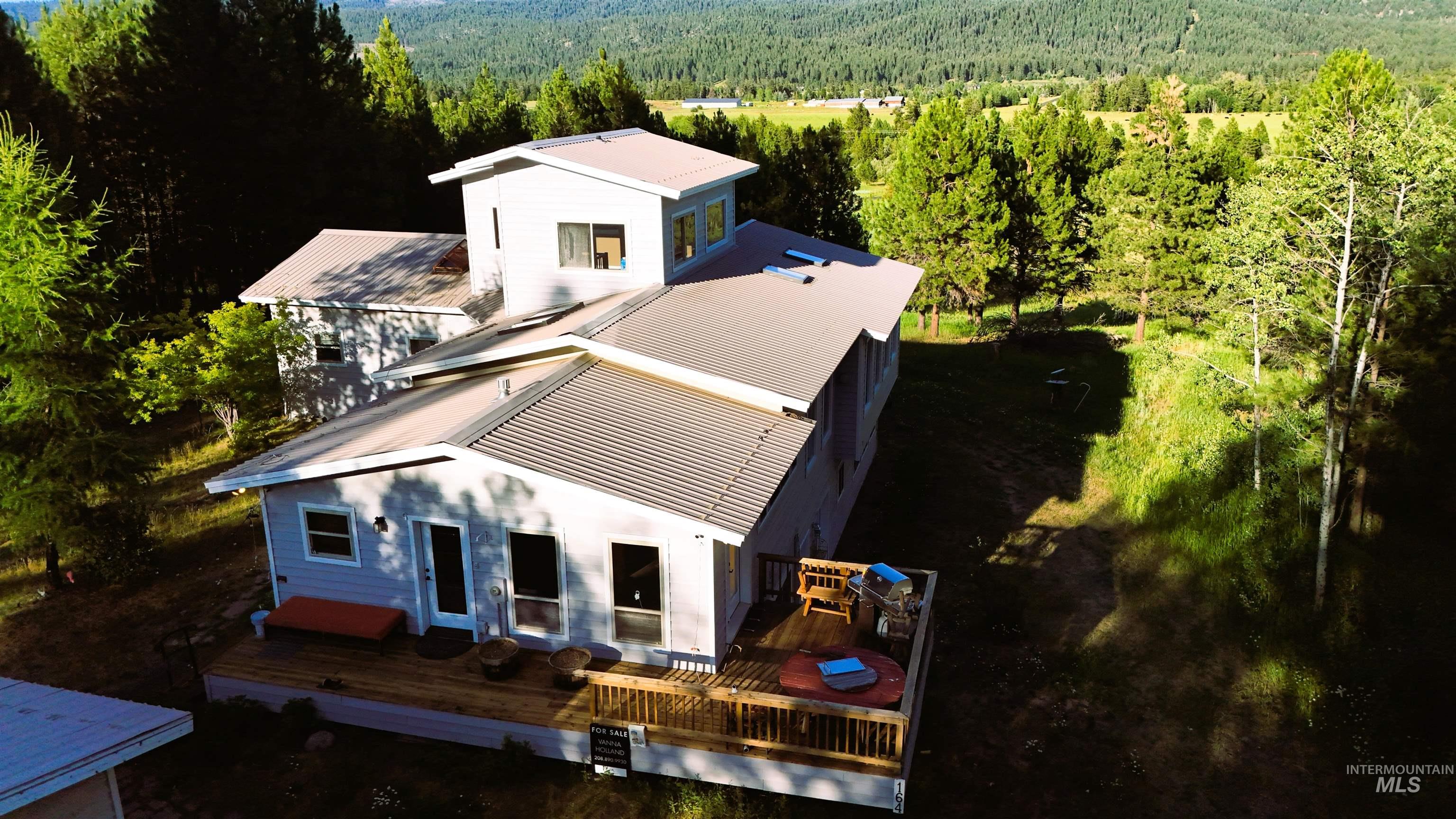 View from above of property featuring a heavily wooded area