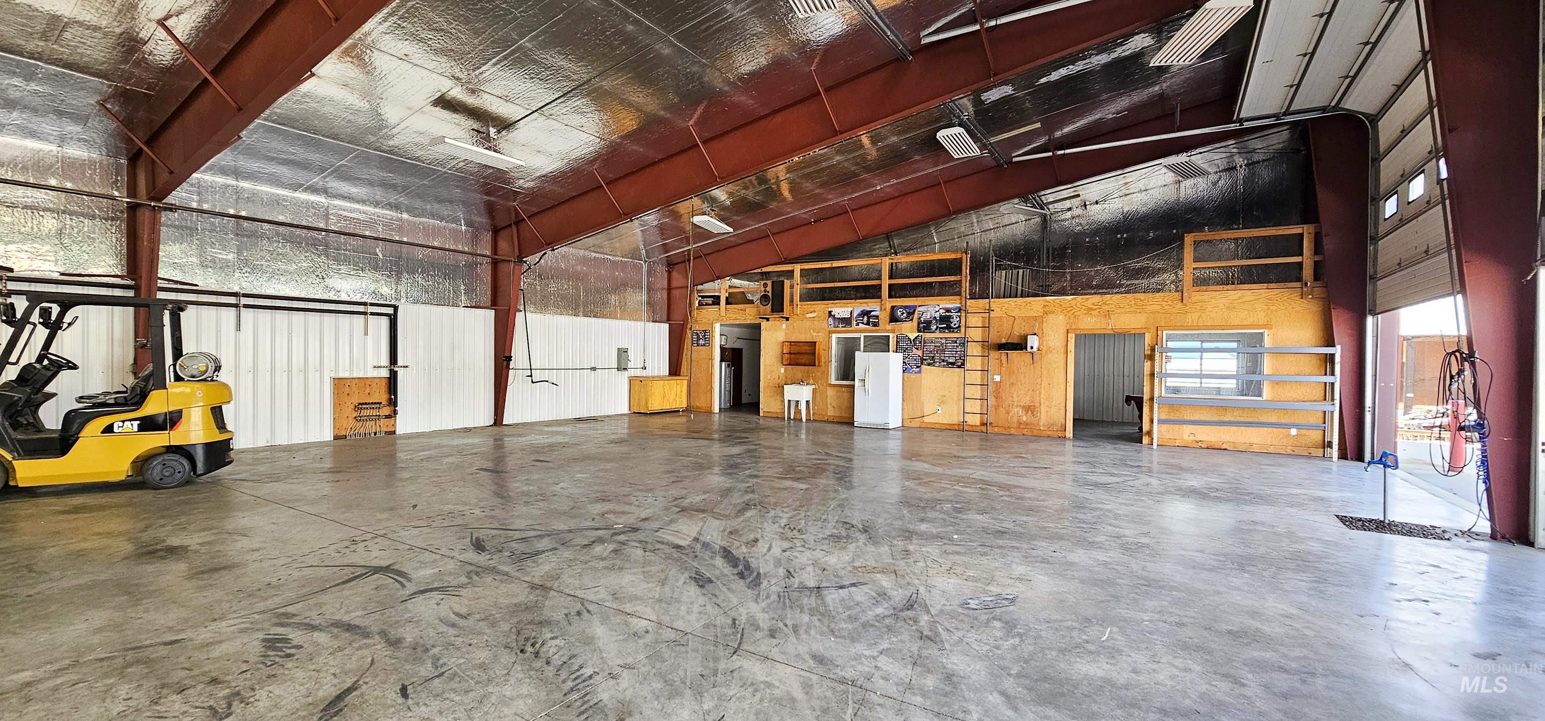 Garage featuring white refrigerator with ice dispenser
