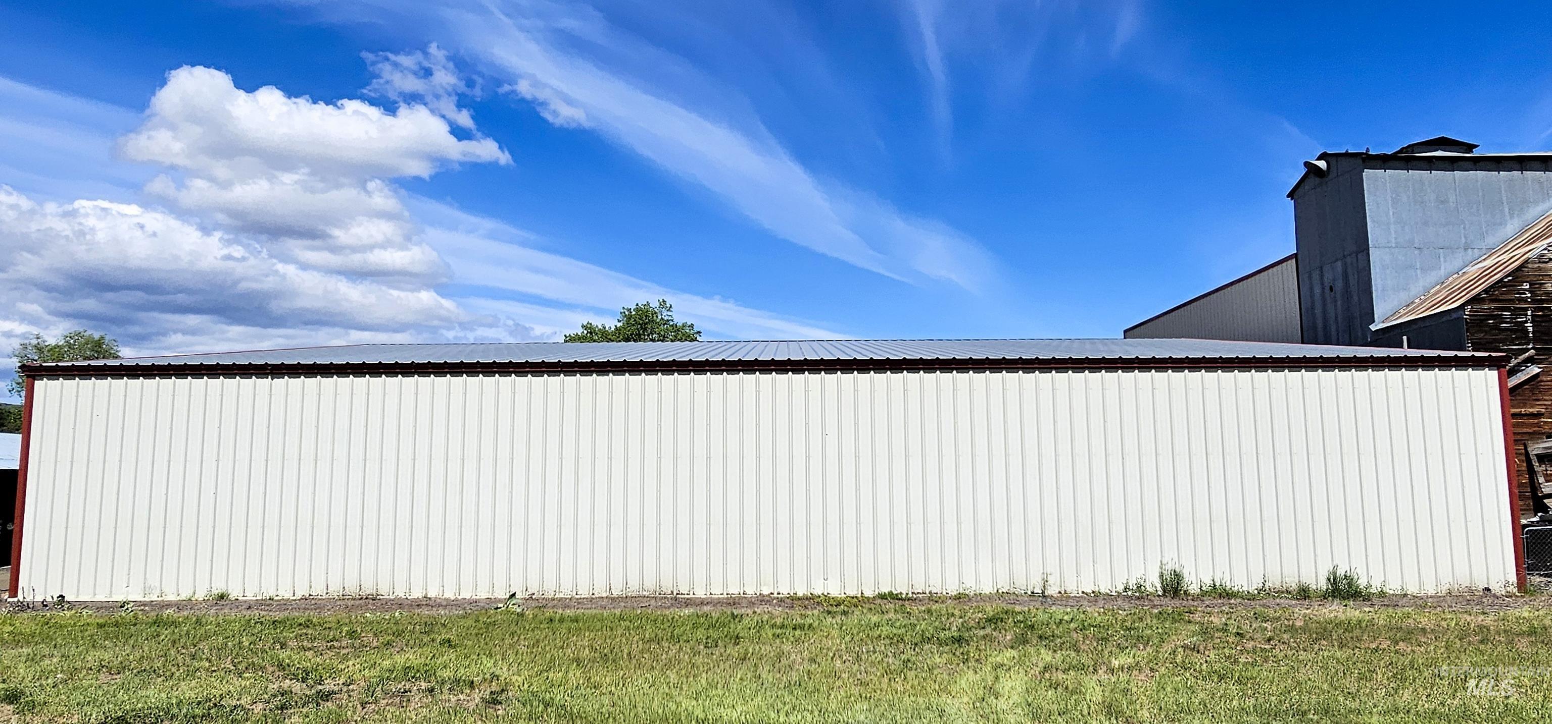 View of property exterior with an outbuilding and a metal roof