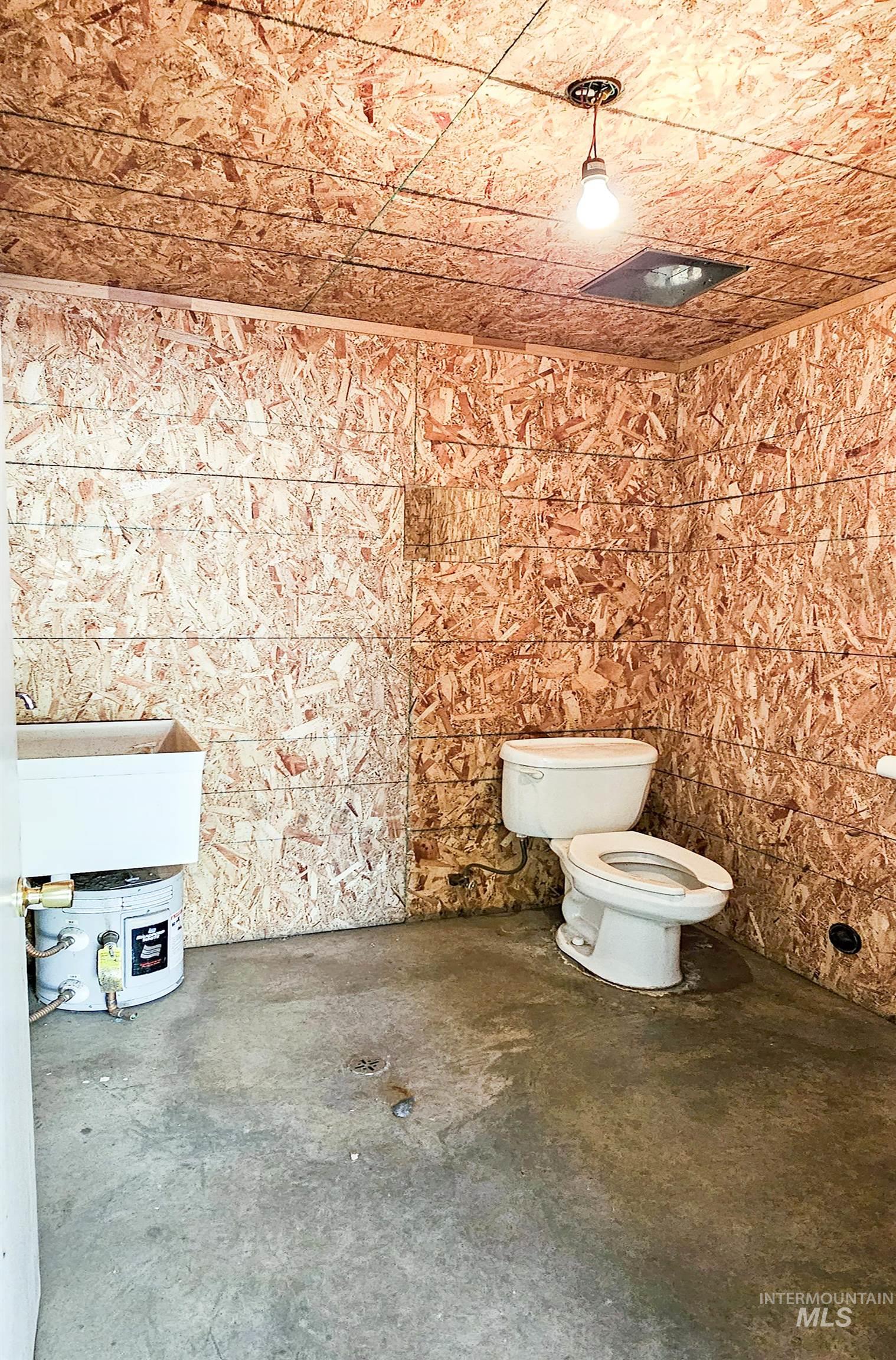 Bathroom featuring toilet and concrete flooring