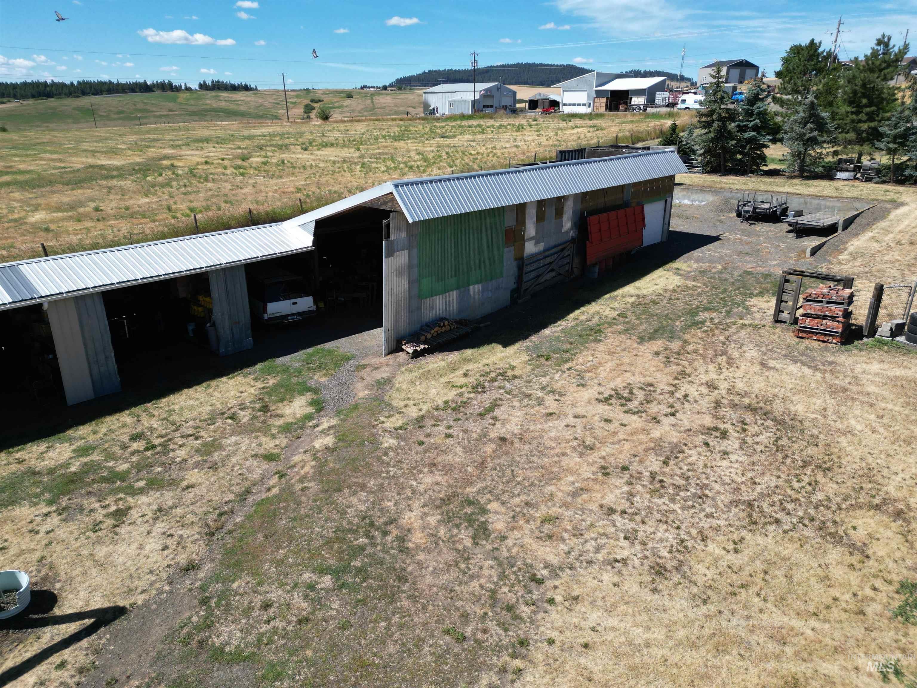 View of pole building featuring a carport and a view of rural / pastoral area