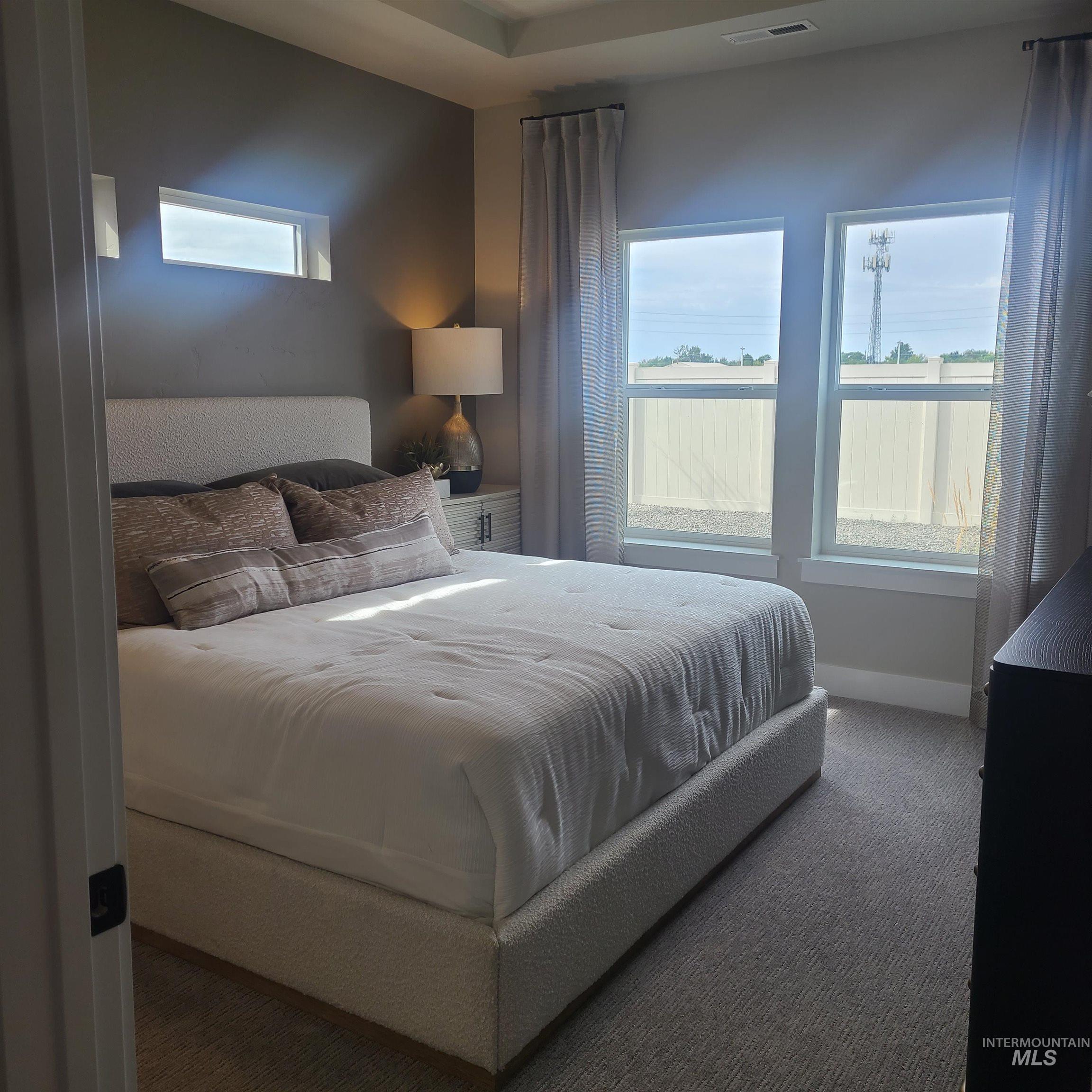 Carpeted bedroom featuring baseboards