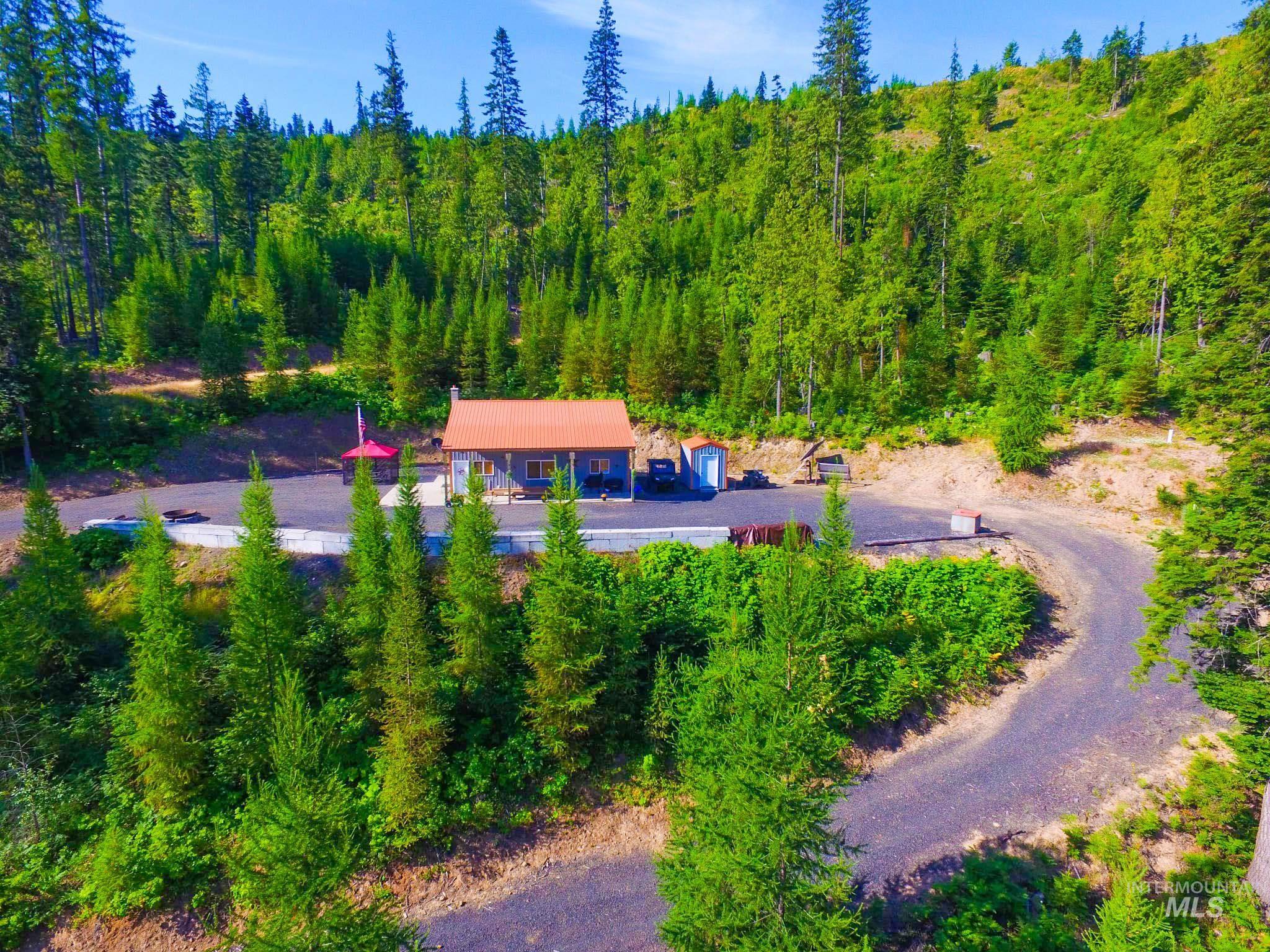 View of subject property featuring a heavily wooded area