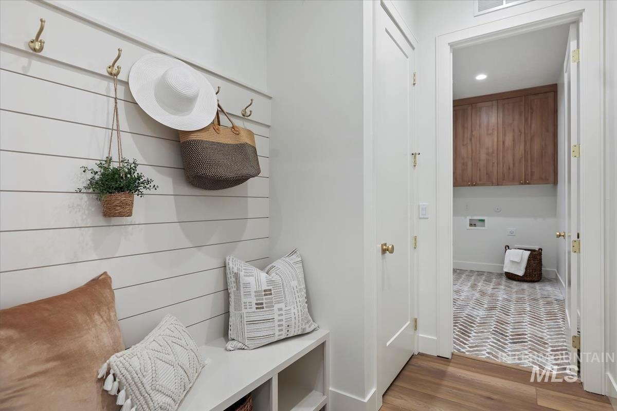 Mudroom with brick floors and recessed lighting