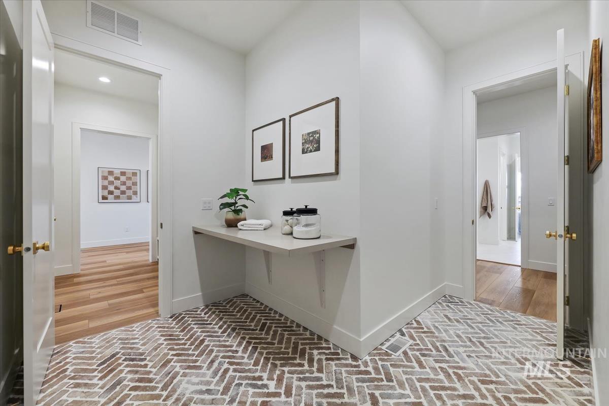 Hall with brick flooring and recessed lighting