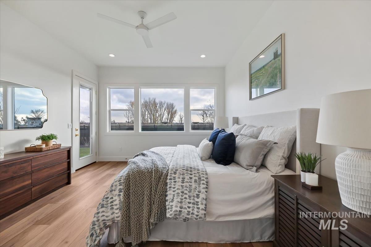 Bedroom featuring access to outside, light wood-type flooring, a ceiling fan, and recessed lighting