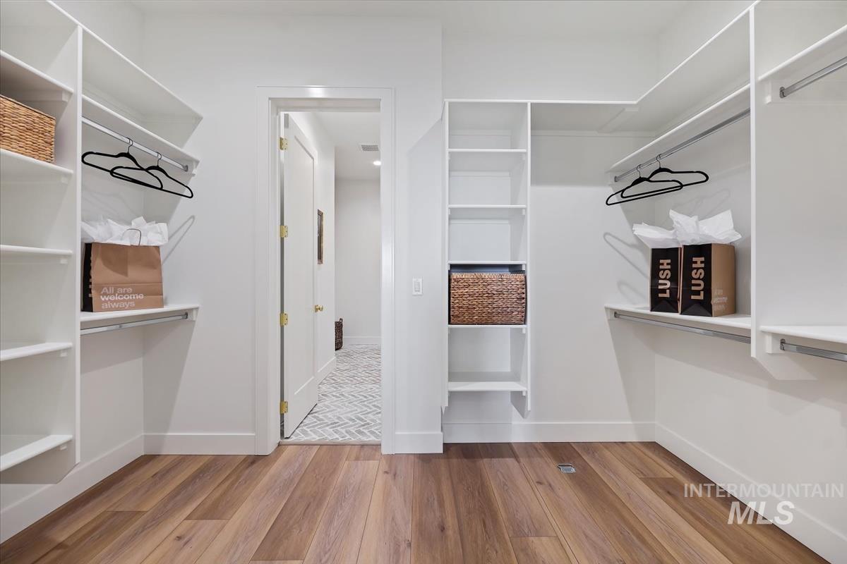 Spacious closet featuring light wood-type flooring
