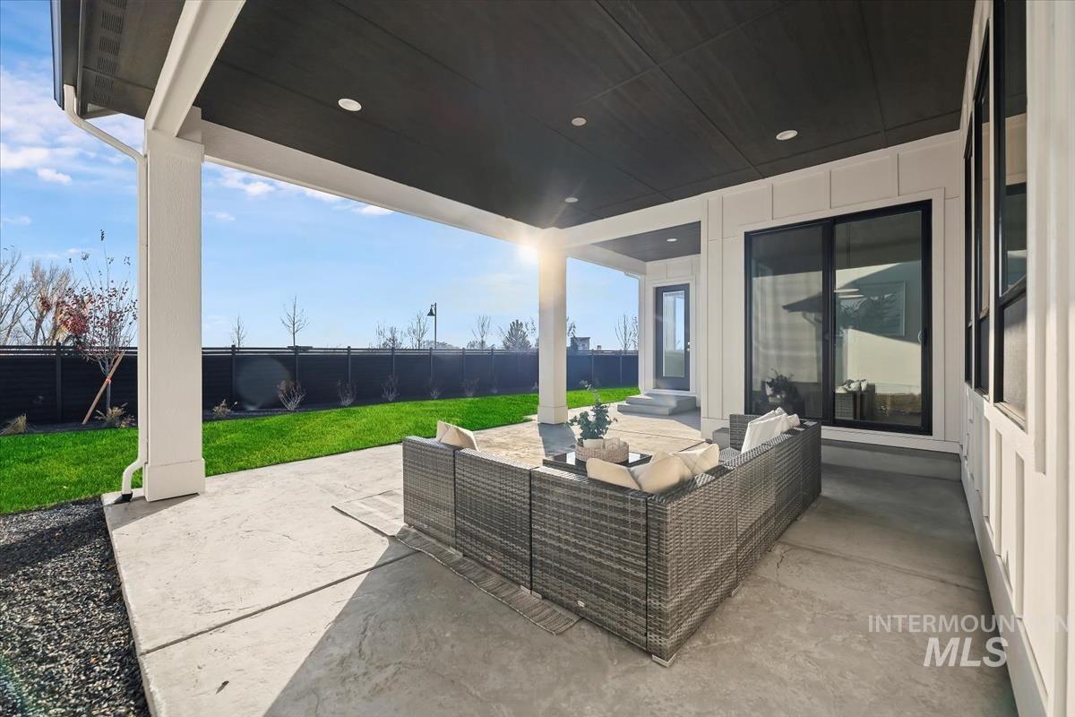 Fenced backyard with a patio and outdoor lounge area