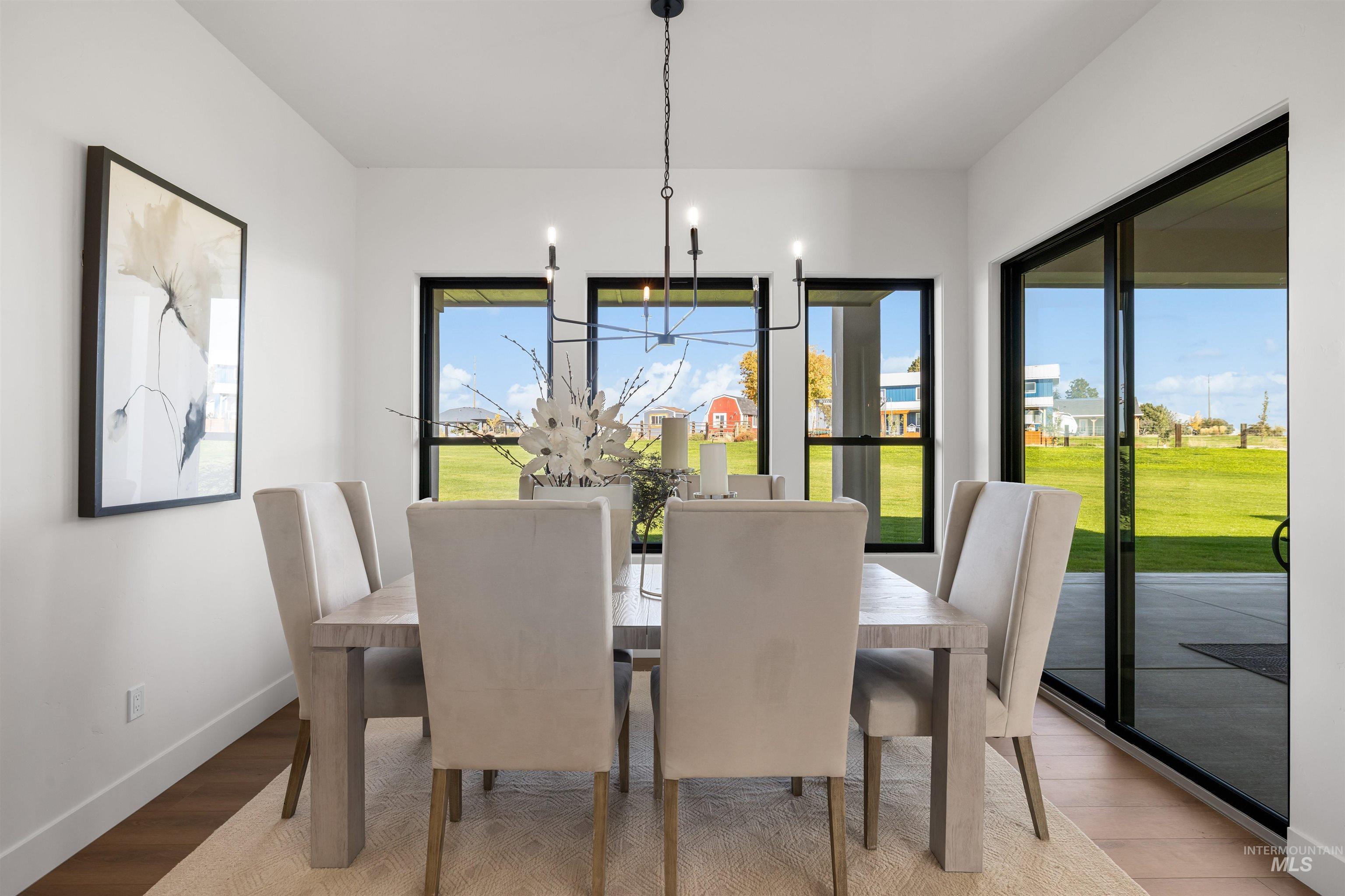 Dining space with light wood-style floors and baseboards