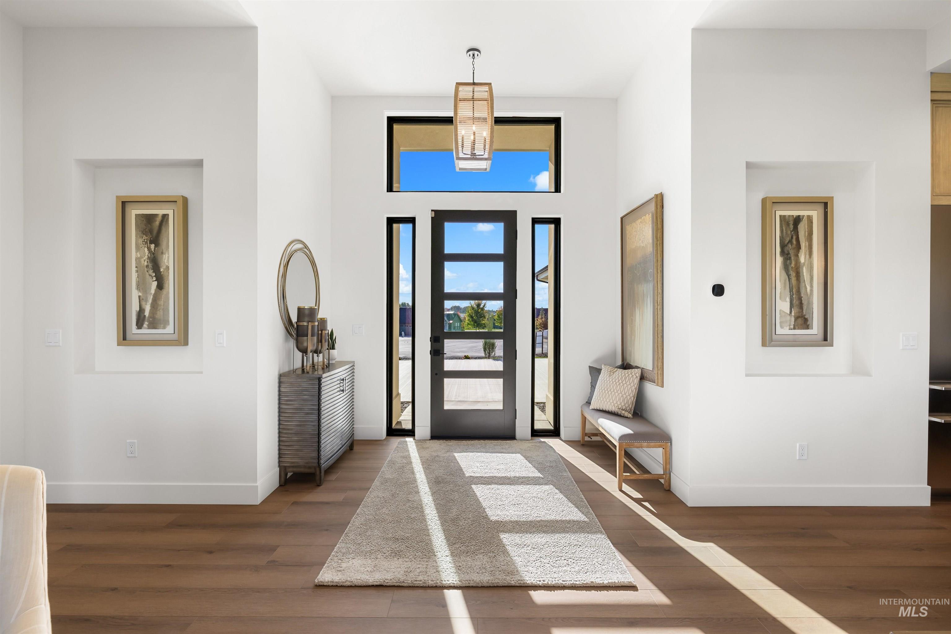 Entrance foyer featuring dark wood-style flooring and a towering ceiling