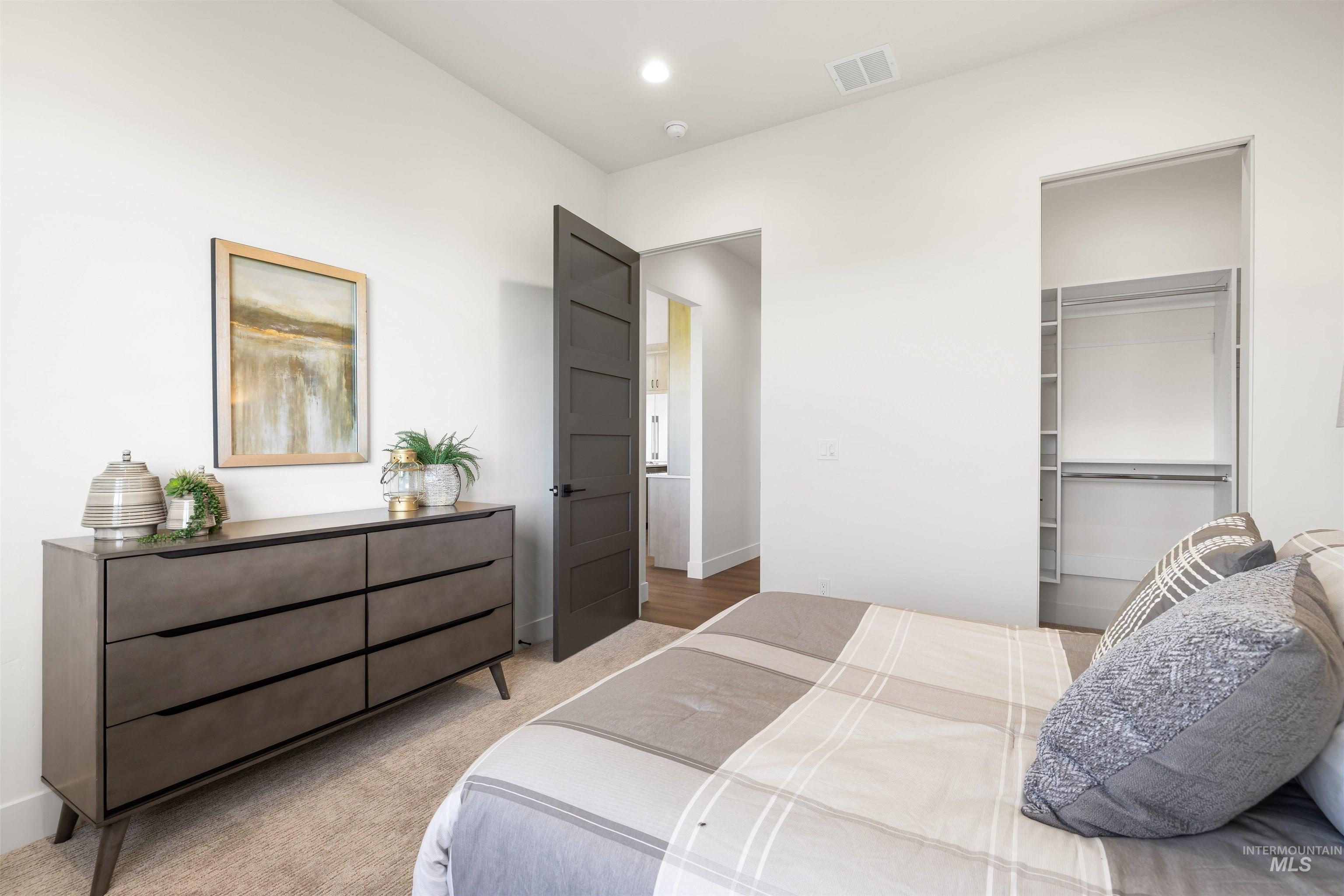 Bedroom featuring carpet, a spacious closet, and recessed lighting