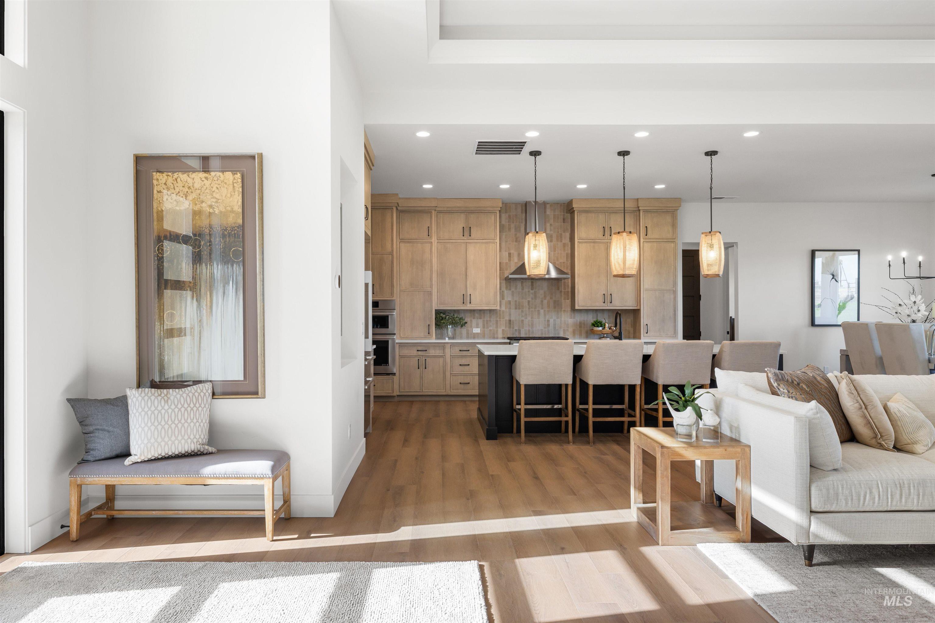 Living room featuring light wood-style flooring and recessed lighting