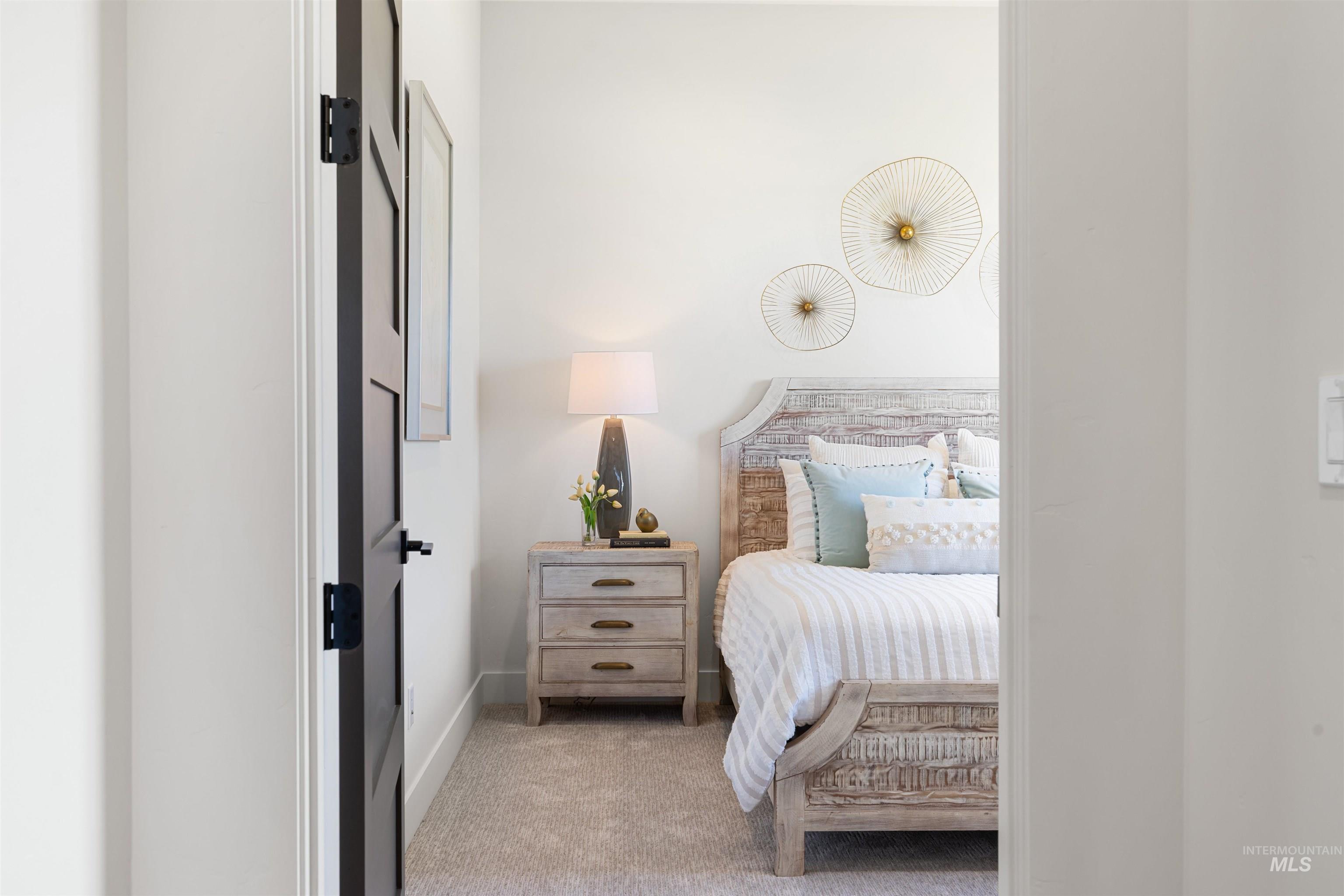 Bedroom featuring light colored carpet and baseboards