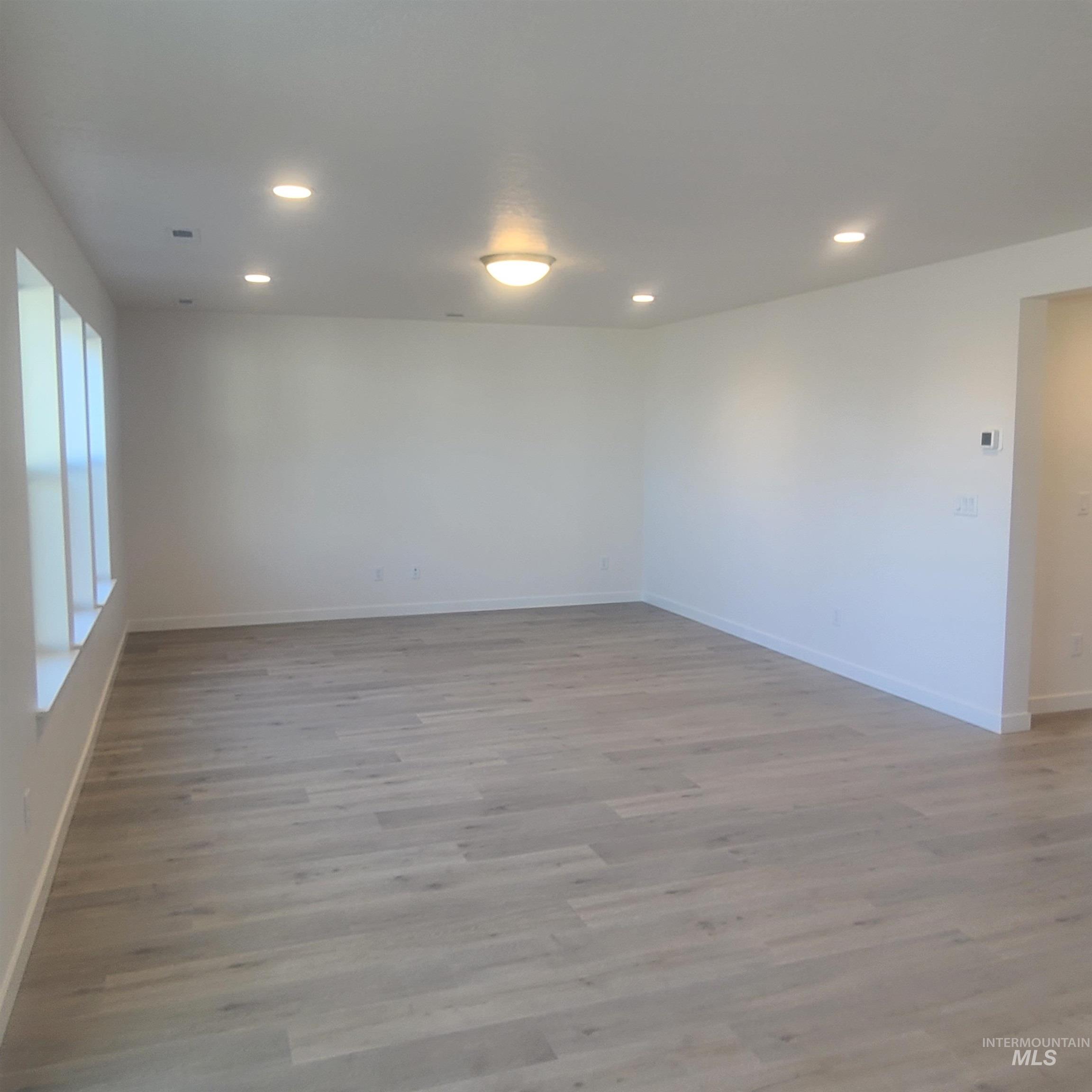 Spare room with recessed lighting and light wood-style flooring