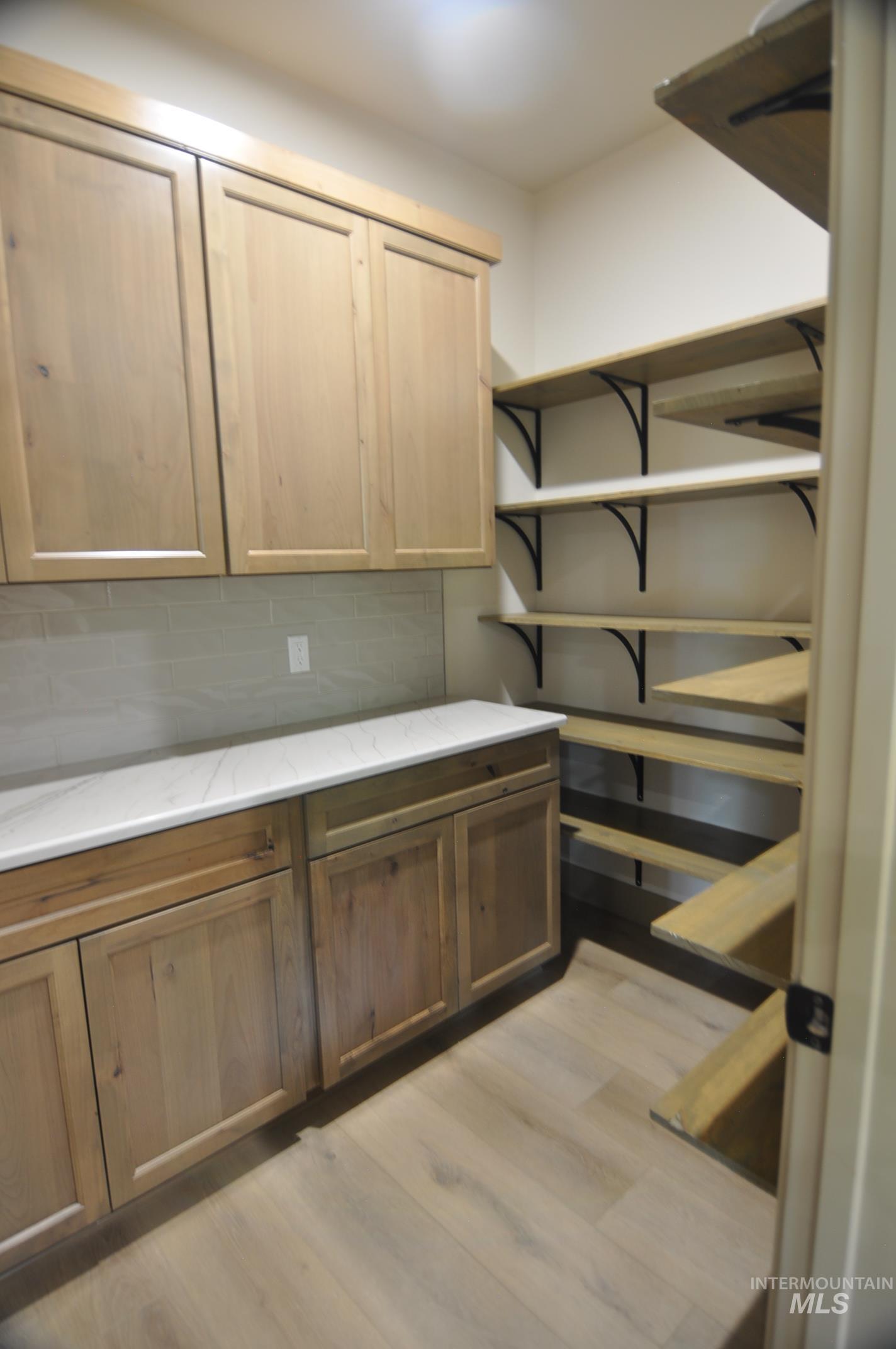 Butler's pantry with shelving storage, cabinets for storage and countertops for appliances to keep them from cluttering up the kitchen.