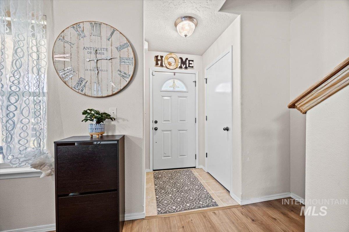 Foyer featuring wood finished floors and a textured ceiling