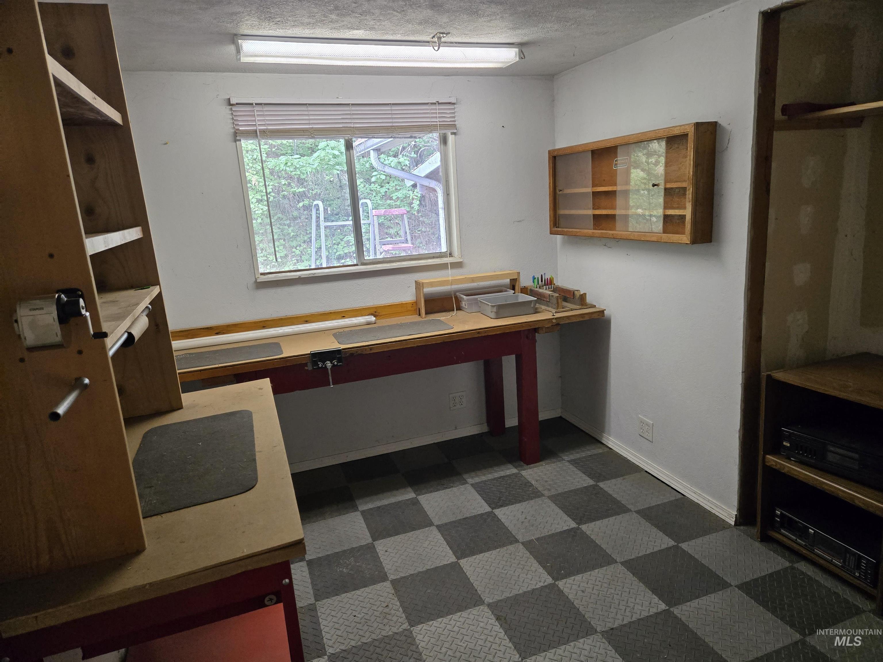 Office with dark flooring and baseboards