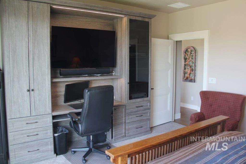 Bedroom with built in study area and baseboards