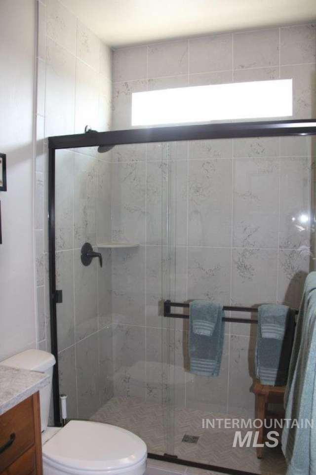 Bathroom with a stall shower and vanity