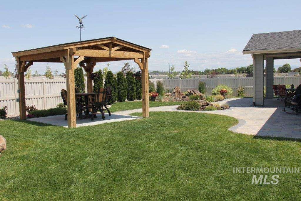 Fenced backyard with a patio area and a gazebo