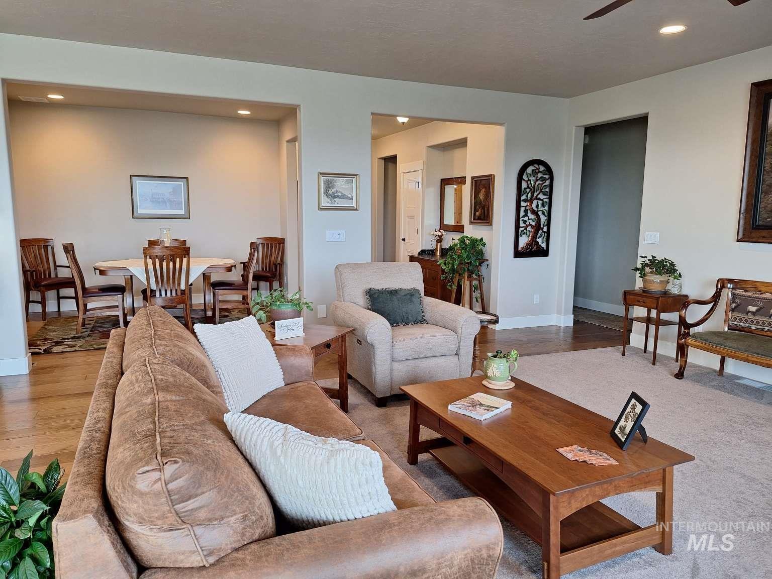 Living room with recessed lighting, wood finished floors, and a ceiling fan